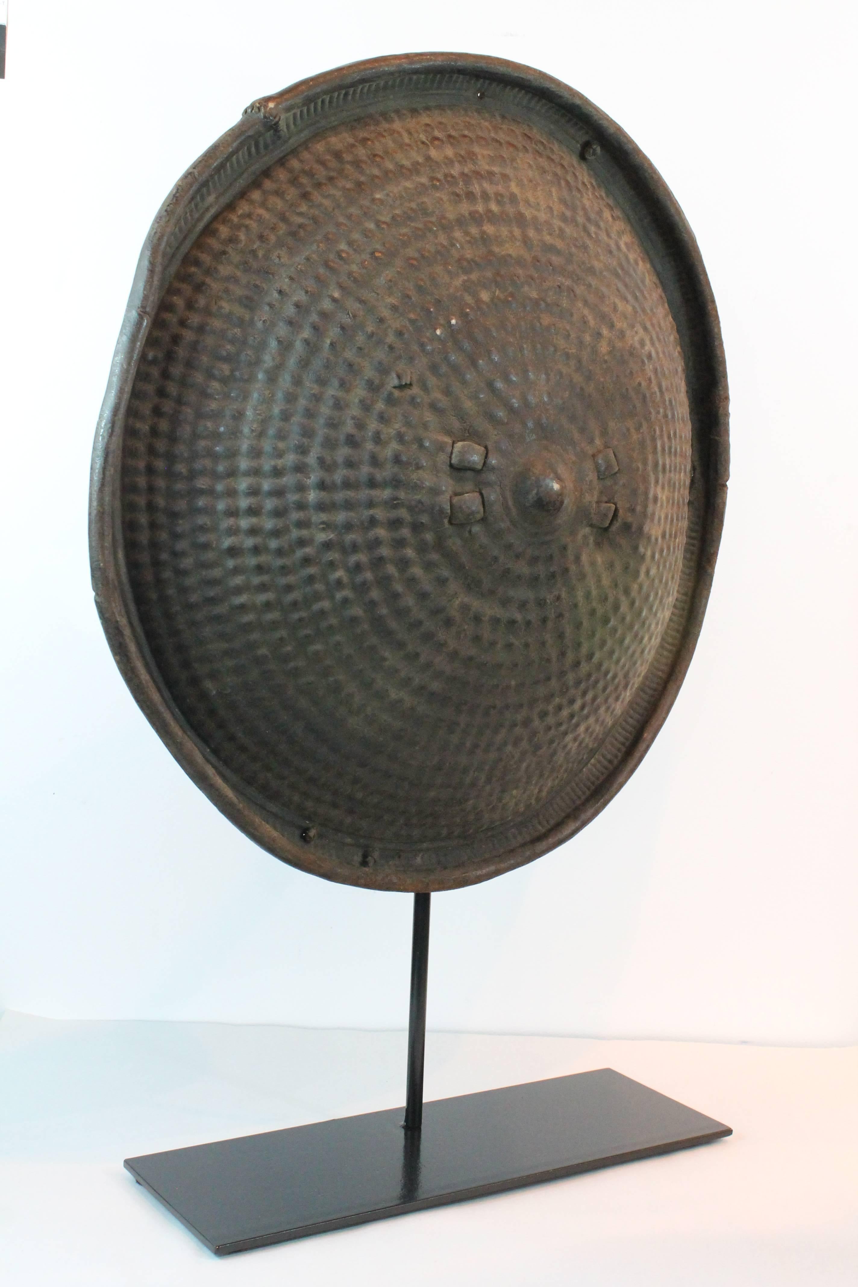 Graphic dimensional thick rhinoceros hide shield from Ethiopia on a custom iron stand.
Fantastic concentric circle design.