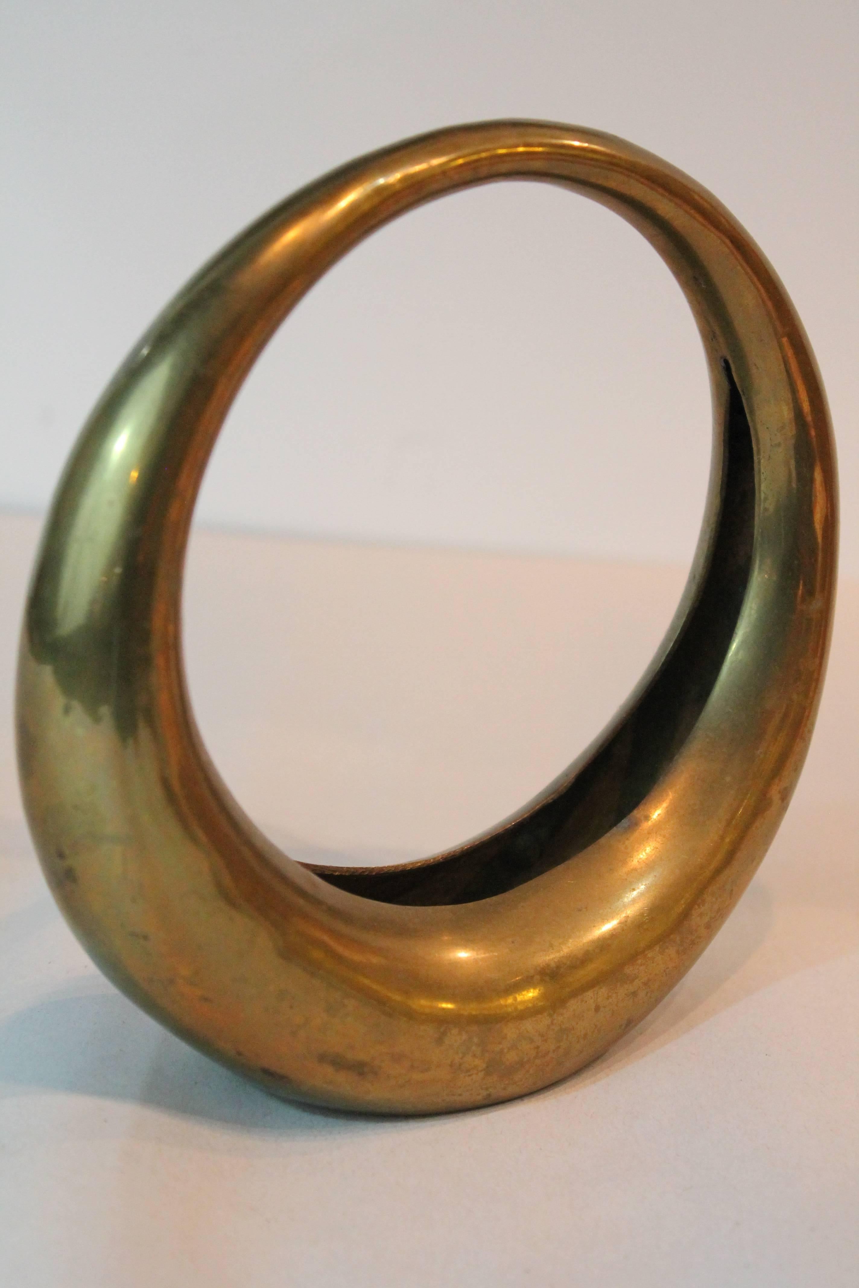 Powerfully minimalist brass moderne vessel with a graceful simple design.
 