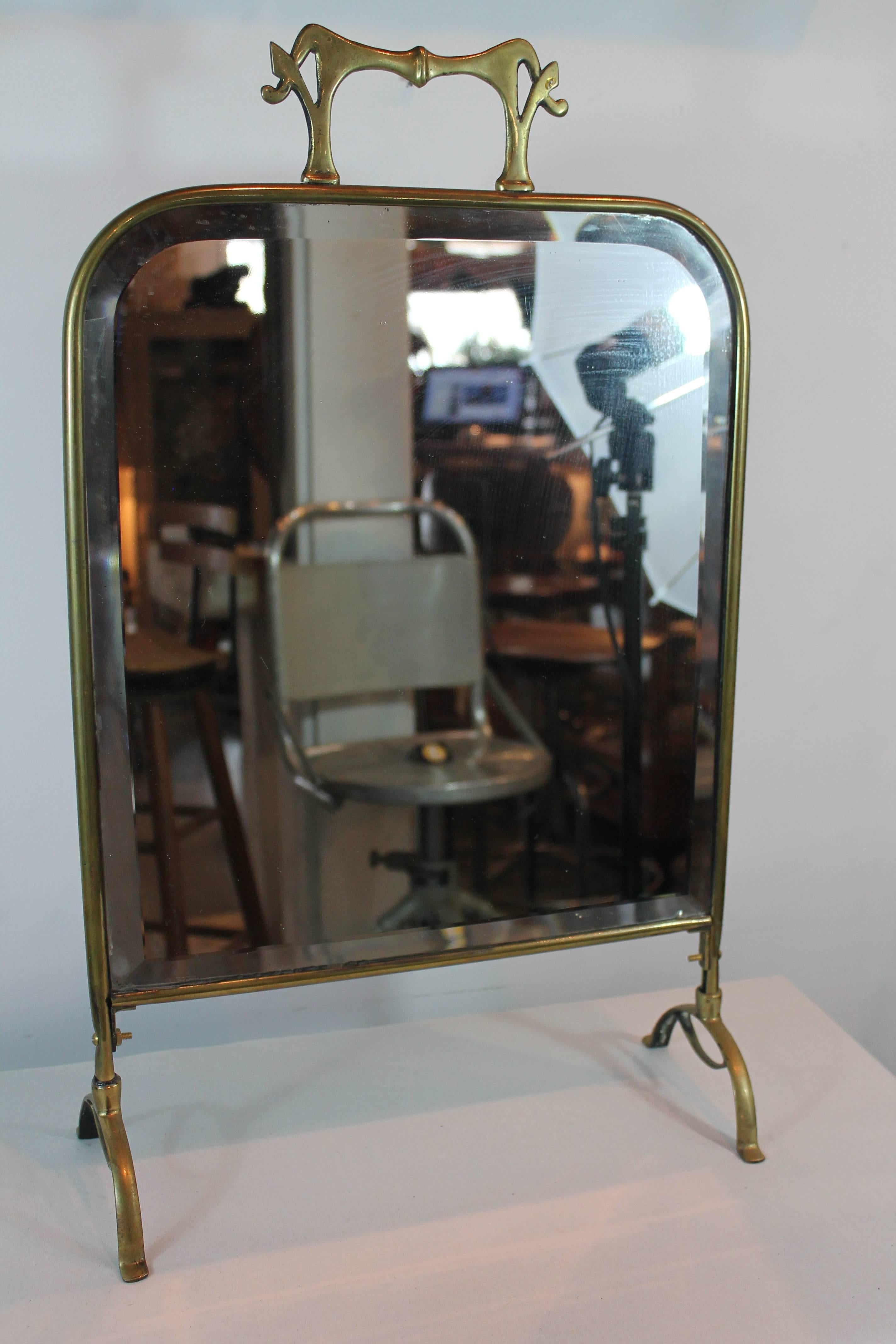 Great simple Nouveau lines on this cast brass freestanding vanity mirror.
Bevelled mirror and elegant footed base.
Has a handle for carrying and was possibly used in a department or clothing store.