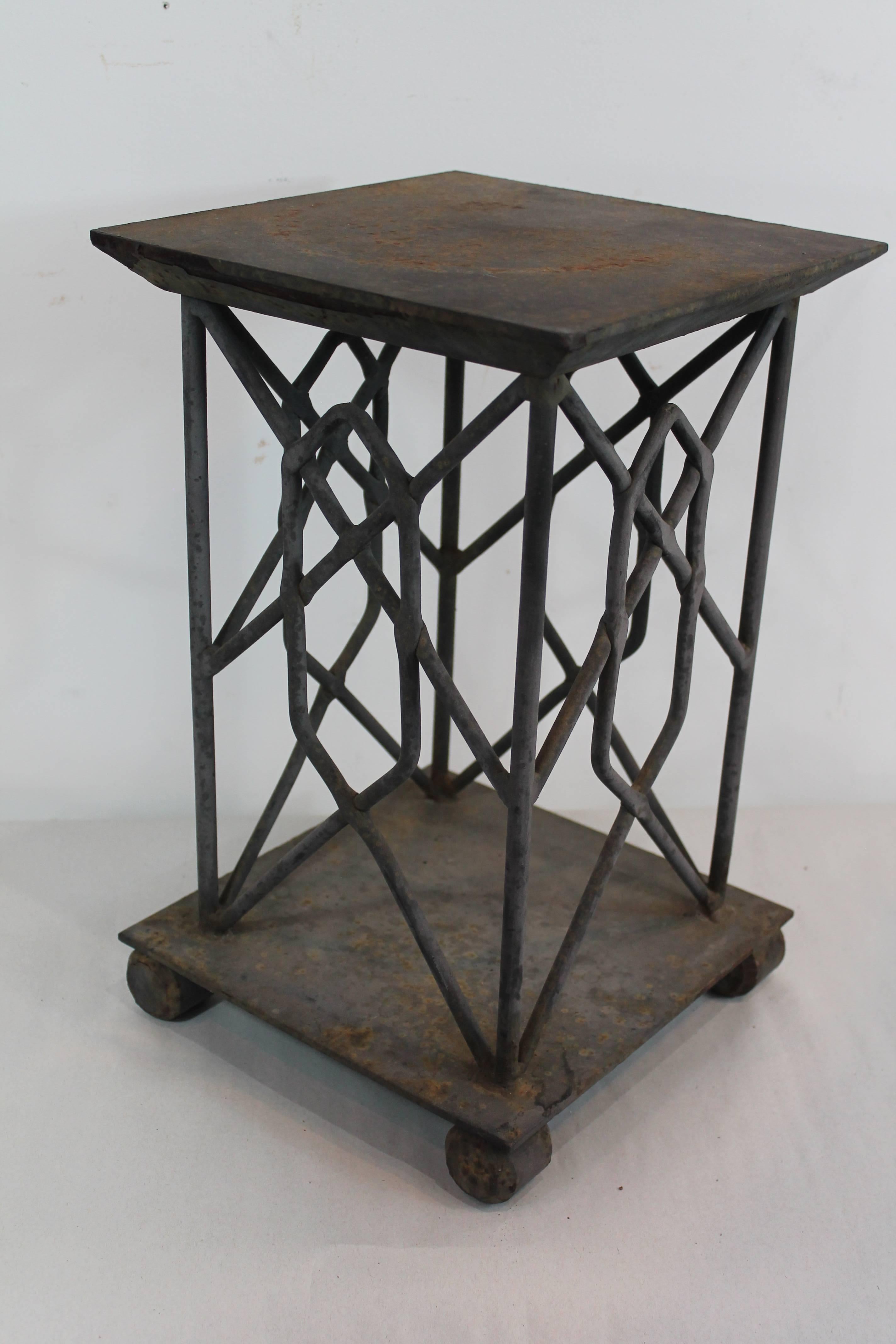 Great graphic hand-wrought iron sculptural side table.
Wonderful simple elegant attention to detail with beveled edge on top and toosie roll feet.
Wonderful pale blue oxidized surface, it was likely used in a garden.