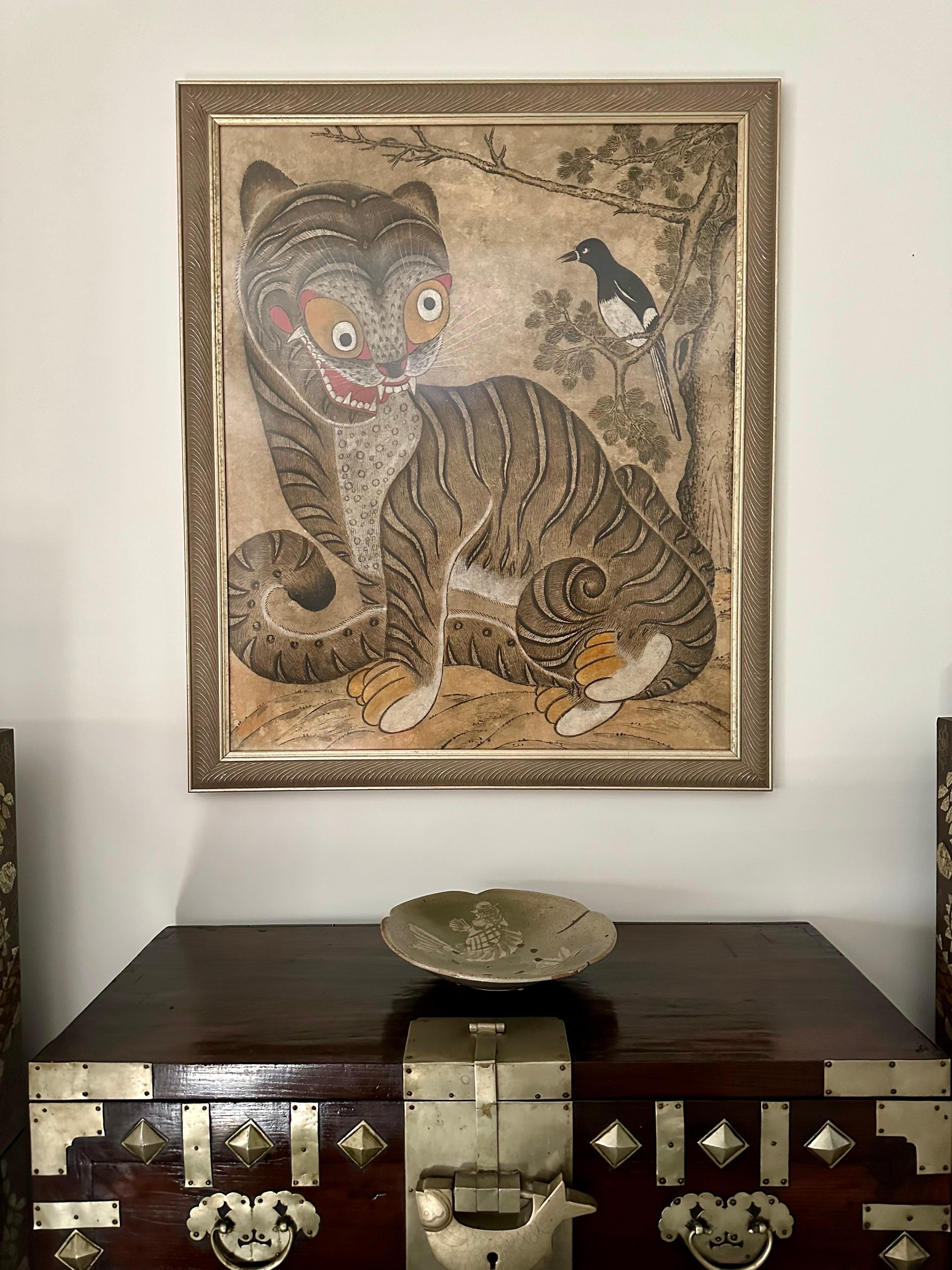 A large Korean folk-art painting framed in a carved gilt frame under museum-quality acrylic glass. The ink and watercolor on paper was dated circa late 19th century to turn of the 20th century toward the end of Joseon dynasty. The work depicts a