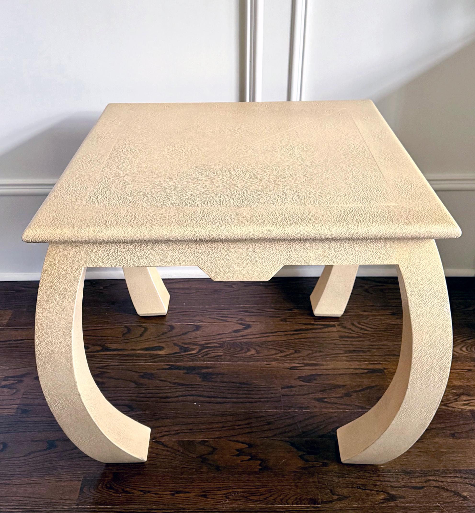 A square end table completely clad in embossed leather that mimics Shagreen skin circa 1970-80s. The versatile table features a skirted top supported four slightly curved legs. The form was inspired by Chinese vernacular furniture with 
