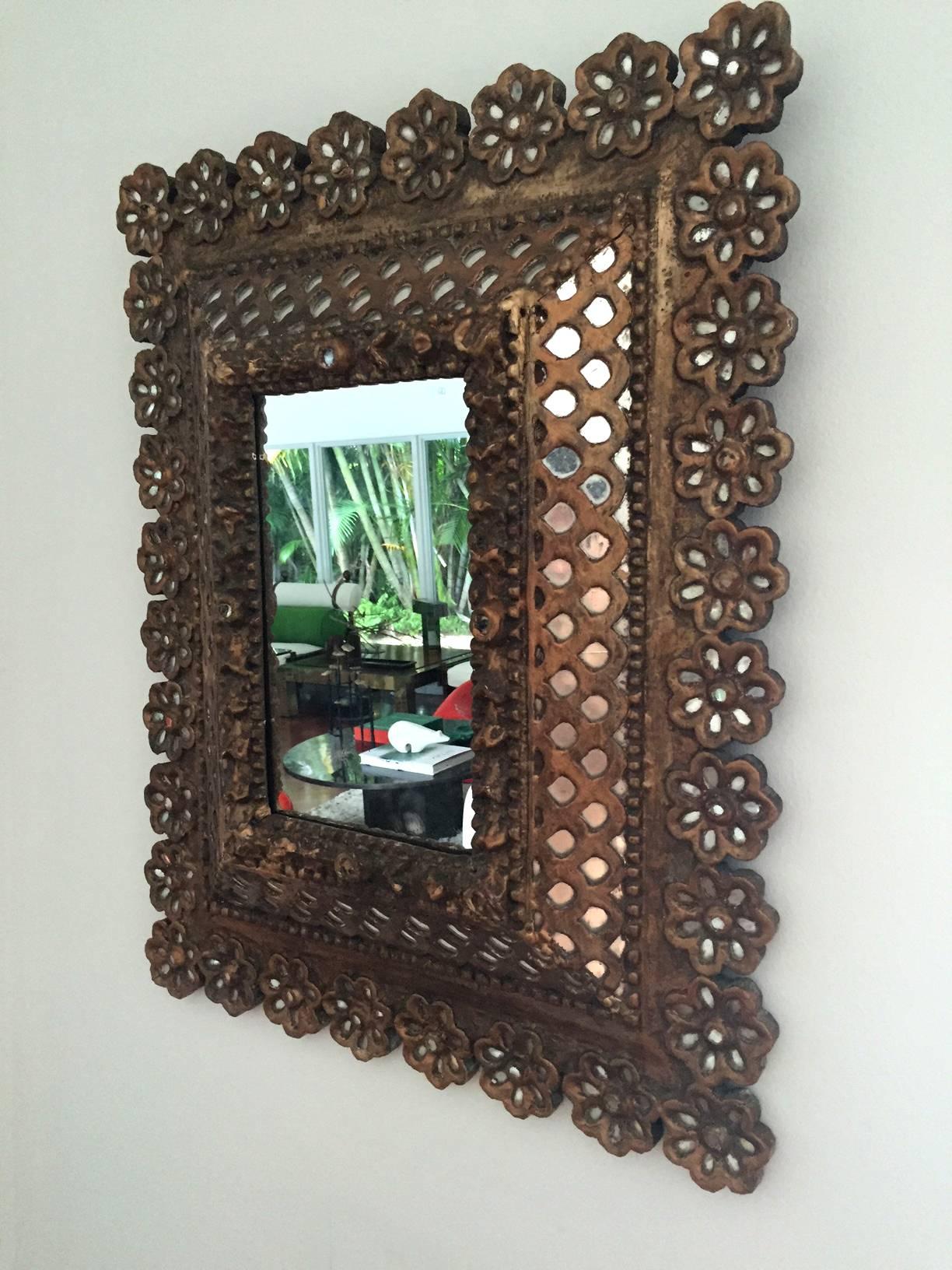 An old giltwood framed mirror from Spanish Colonial era, circa 19th century. It features a center mirror 7