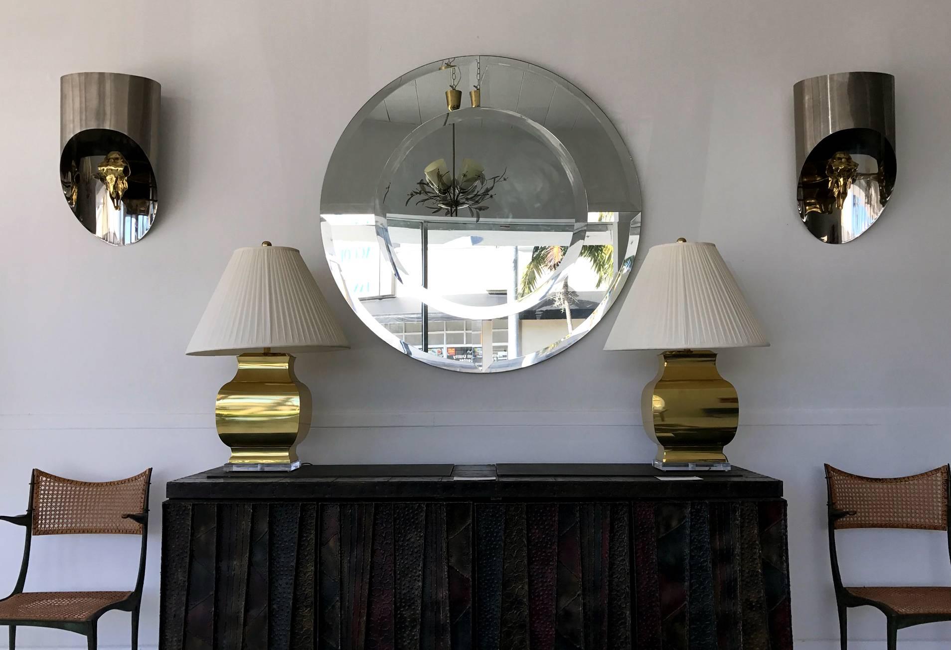 Impressive in size, striking in appearance, this "Saturn" mirror was designed and produced by Karl Springer during his revival of Glamor Interior in the 1970s and 1980s. The beveled and layered construction evokes a sense of aesthetic of