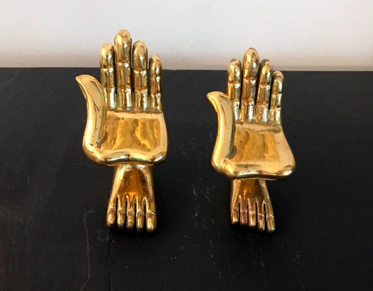 Two iconic wood and gold-leaf hand and foot sculptures by the celebrated Mexican-American surrealist artist Pedro Friedeberg. Miniature tabletop size that measures approx. 3