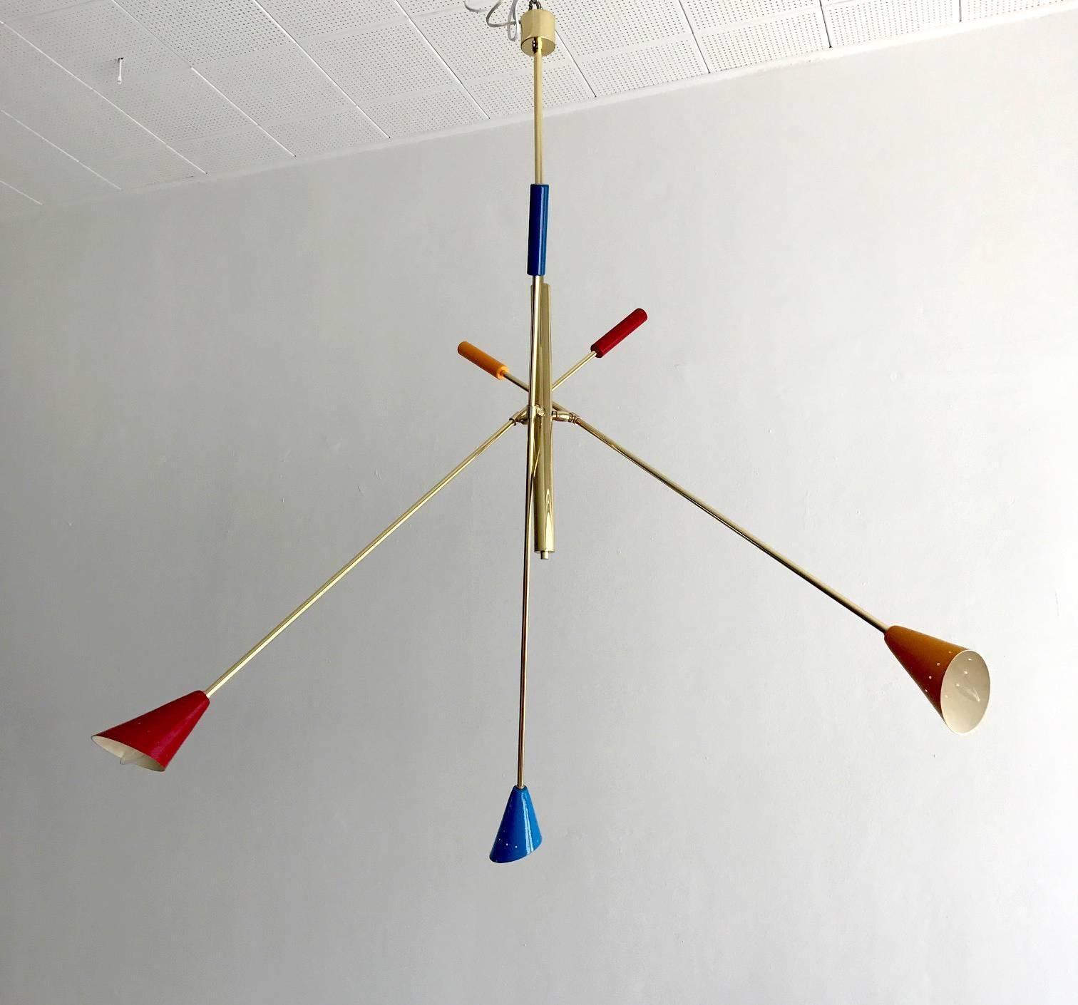 A Mid-Century Italian ceiling light, circa 1950s, in the style of Angelo Lelli. Brass stem with three articulated arms with multicolored shades. Bespoken chandelier in large-scale. 
Size is flexible depending on the adjustment of the arm, which