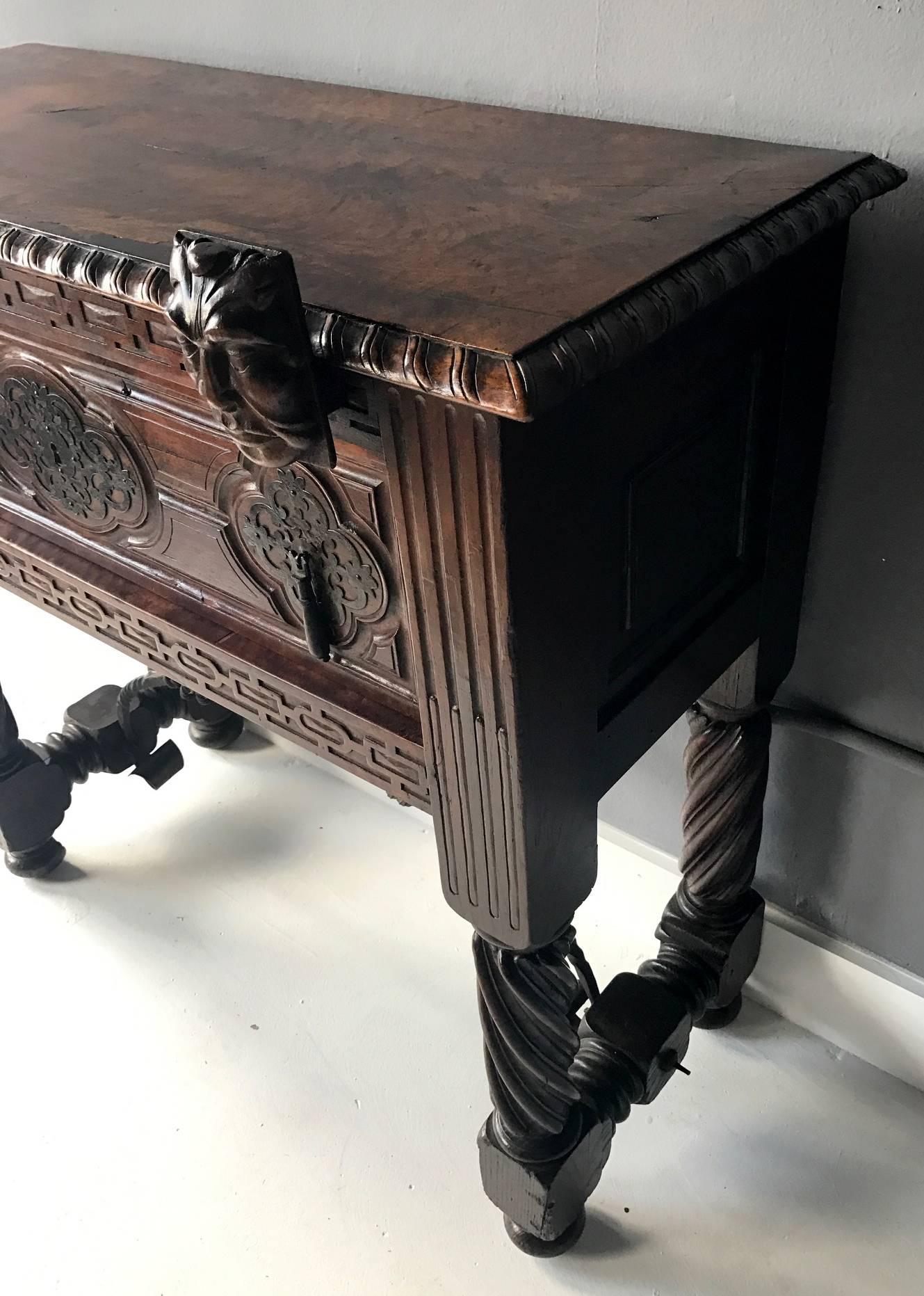 An circa 19th century Spanish Colonial console table with a drawer, likely from Mexico, was made with mahogany and walnut. The table can serve as a small sideboard but was likely originally used as a supporting cabinet/pedestal for a papelera or