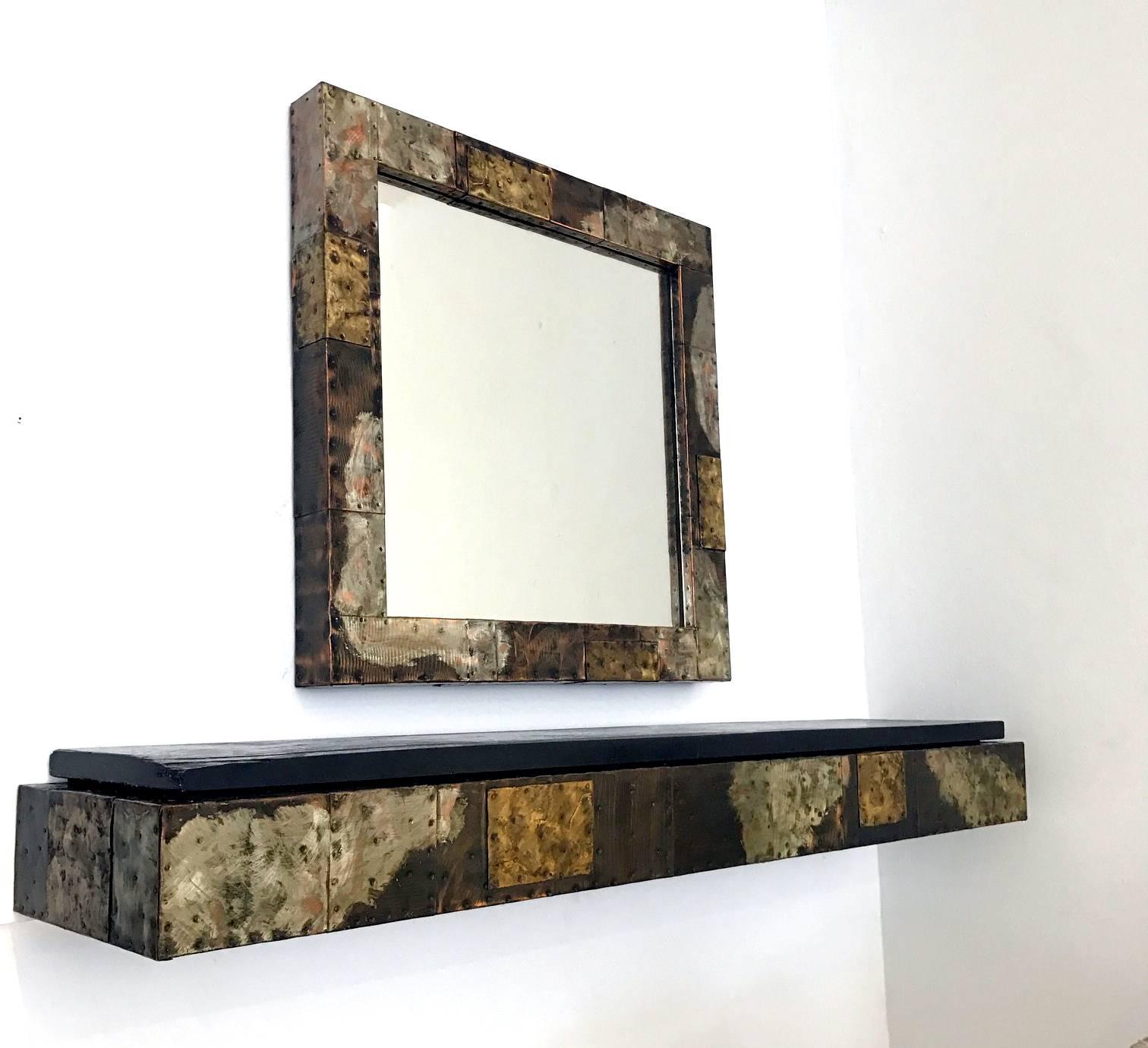 A bespoken metal patchwork wall hang console and mirror by Paul Evans for Directional Inc, circa 1970s. Iconic patchwork of copper, zinc and brass with handmade nails. Slate top. Floating design.
The console is 60 Wx13 D x7 H and the mirror