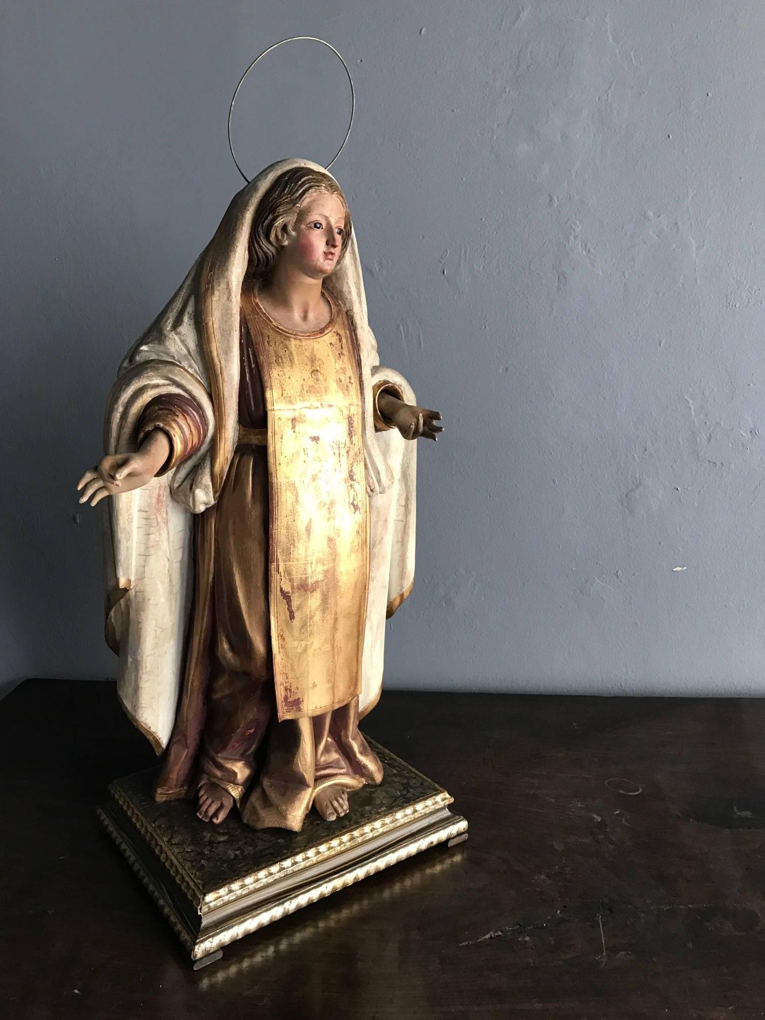 A most spectacular antique Spanish Colonial figure of Madonna, Mexico circa 19th century possibly earlier. Constructed in plaster with carved and gilt wood accent. Realistic in style, and of the highest artistic expression and craftsmanship, this