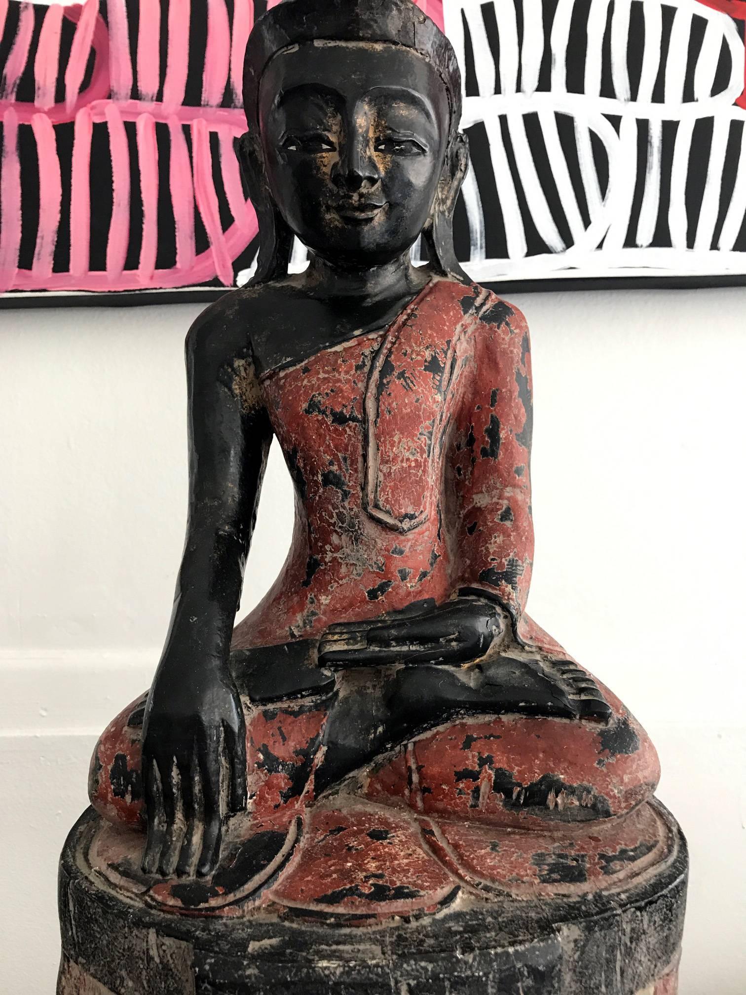 On offer is a craved wood polychromed Buddha from Burma, Southeast Asia, circa 19th century. The Buddha is seated on an unusual double-lotus throne in an 