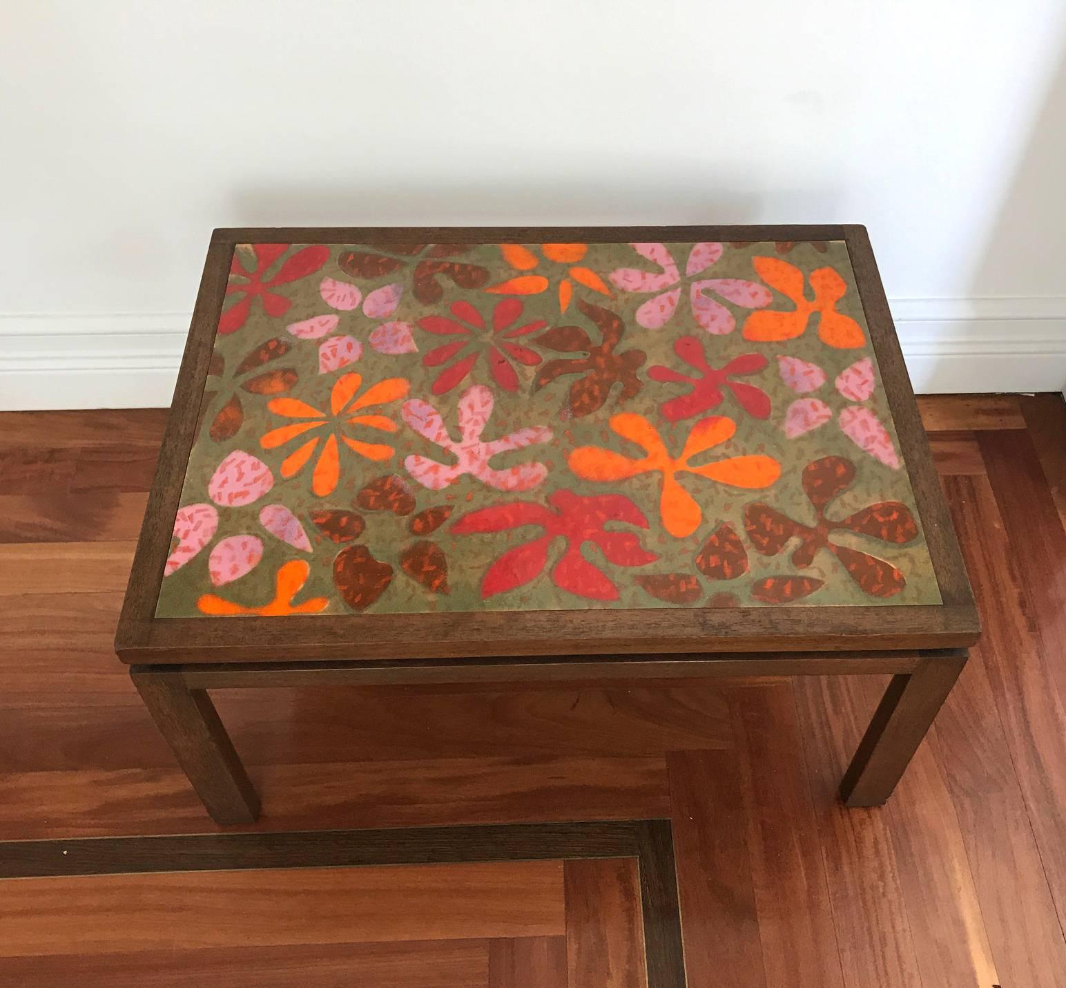 A beautiful side table or small coffee table by Harvey Probber, circa 1950s. Elegant and Minimalist form in mahogany with a rare top surface of colored enamel brass by Arpad and Ilona Rosti. The Rostis were artists/crafters who started out as