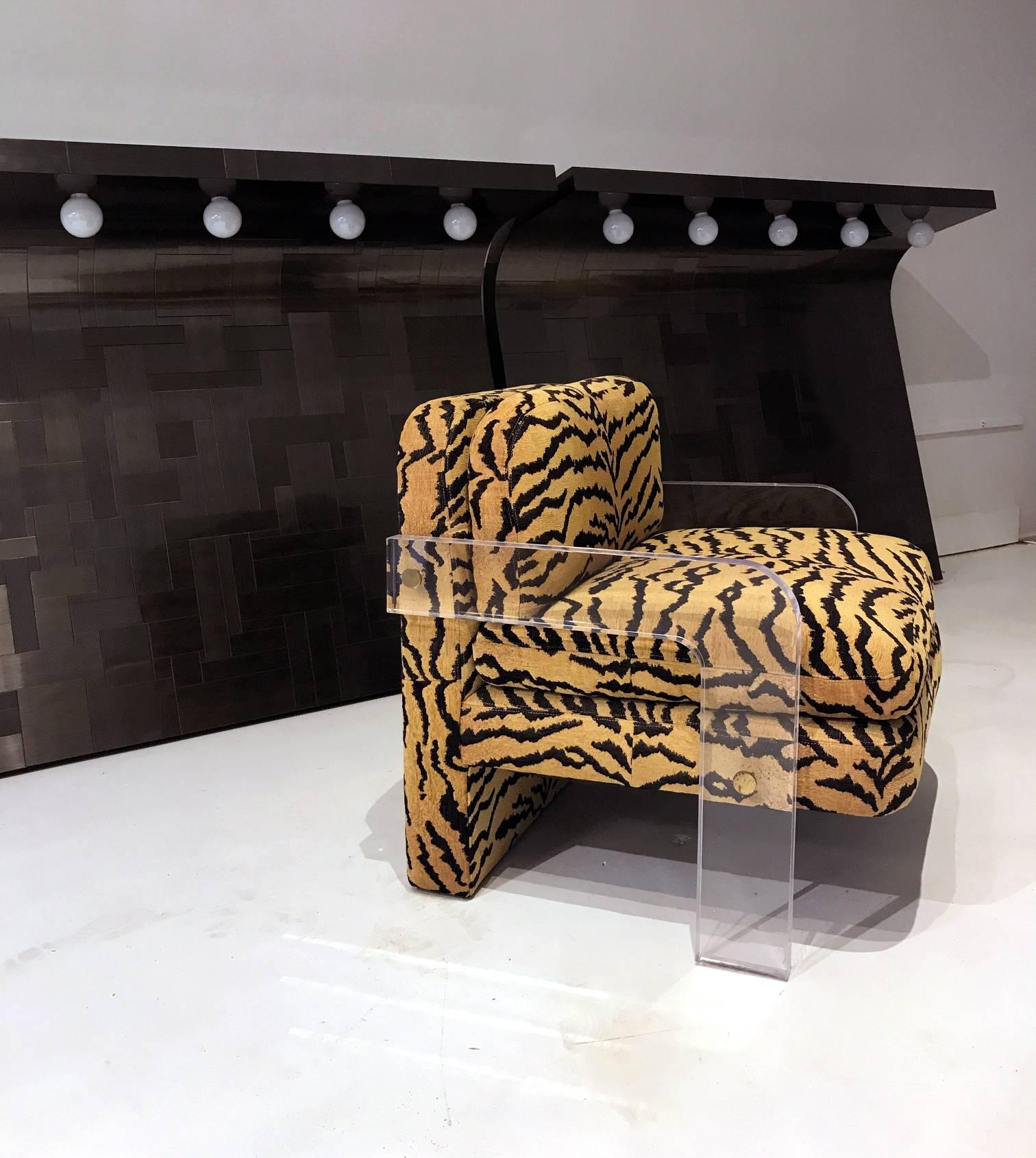 A fantastic cubist lounge chair constructed in Lucite with exposed brass hardware, designed by Vladimir Kagan, circa 1970s. Modern and striking with contrasting tiger skin print upholstery that is likely original from the production.
 