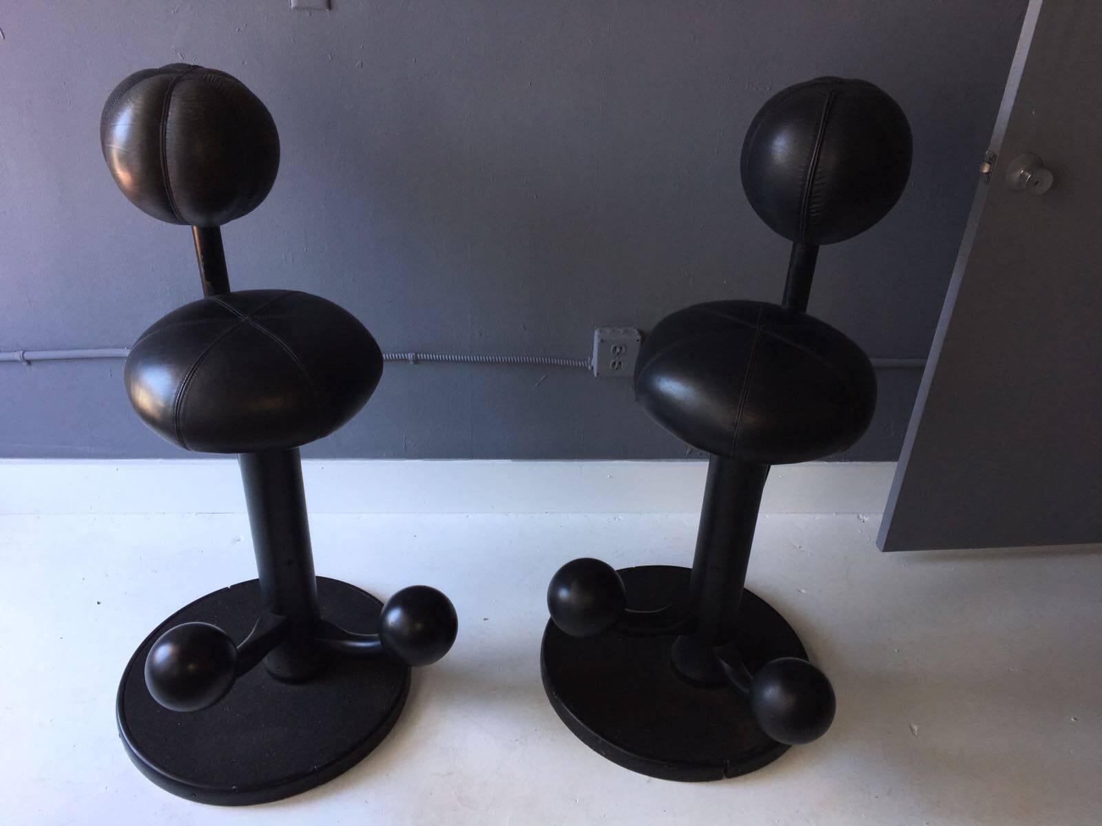 A pair of very cool bar stools from Norway designed by Peter Opsvik circa 1980s. With a Postmodern playfulness but rooted in the Scandinavian concept of "Hygge", the bar stools seem to morph from a group of balls linked by tree trunk, yet