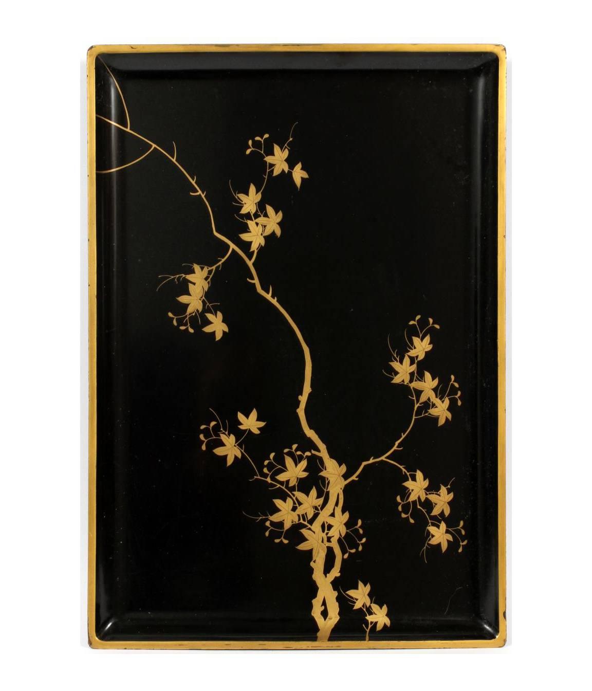 A black lacquered tray, decorated with a gilt branch. Measures W.20 1/4" x 14".
W 10"-14": Includes one footed tray with a few blossoms, W 10 3/4" x 10 3/4"; one black lacquered tray with pine branches, W.14 3/4"