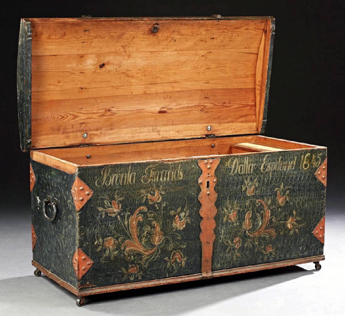 A domed pine wedding trunk of Scandinavian origin, like from Sweden or Norway circa mid 17th c discovered in an old American southern plantation. 
The trunk is decorated with polychrome floral painting on the front and iron hardware strapping. The