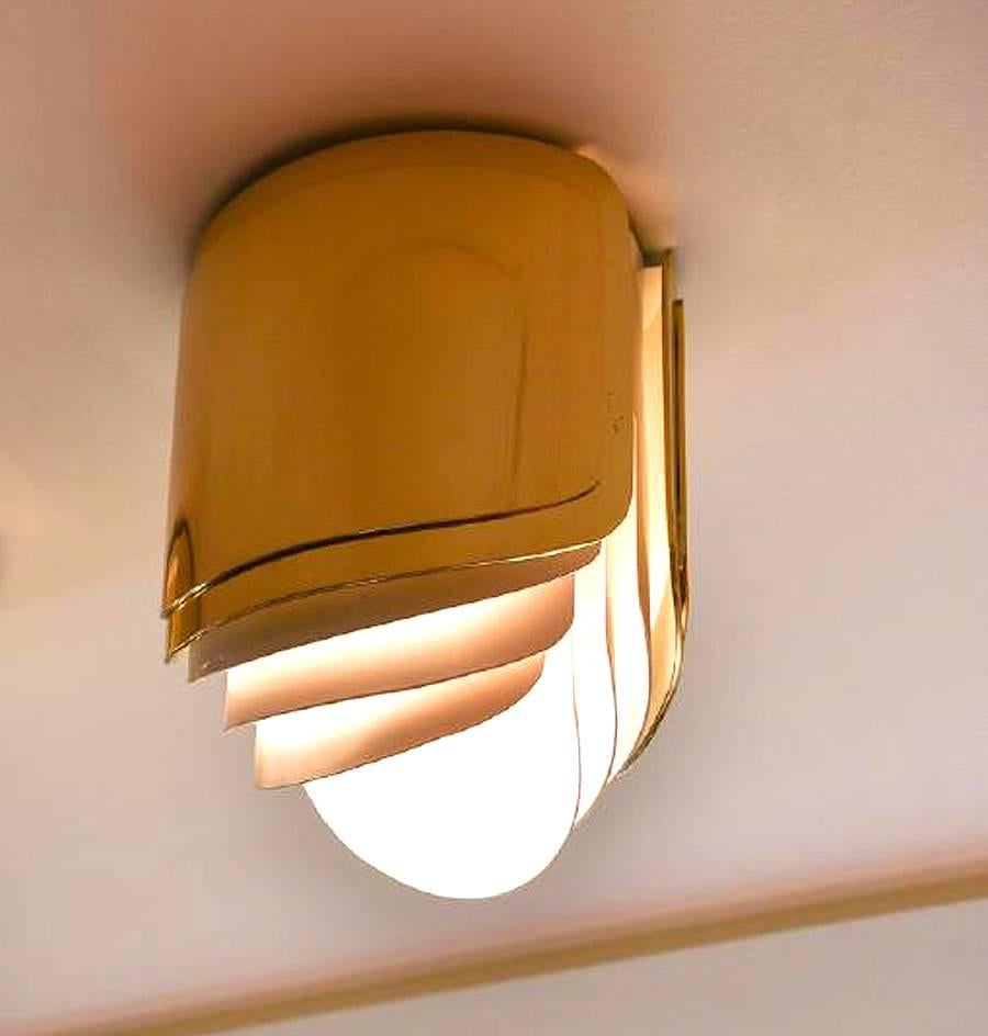 Custom design by Warren Platner for a private house in Connecticut, these ceiling lights are a rarity in the designer's repertoire. Constructed in polished brass shield with white enameled steel louver, these lights are a departure from the popular