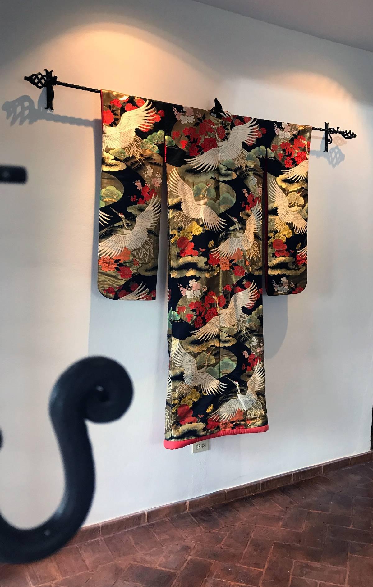 A truly exceptional Japanese ceremonial kimono circa 1930s in Art Deco fashion. Black silk background with elaborate and intricate embroidery in color and gold threads that depict auspicious symbols such as the pines trees, white cranes in flights,