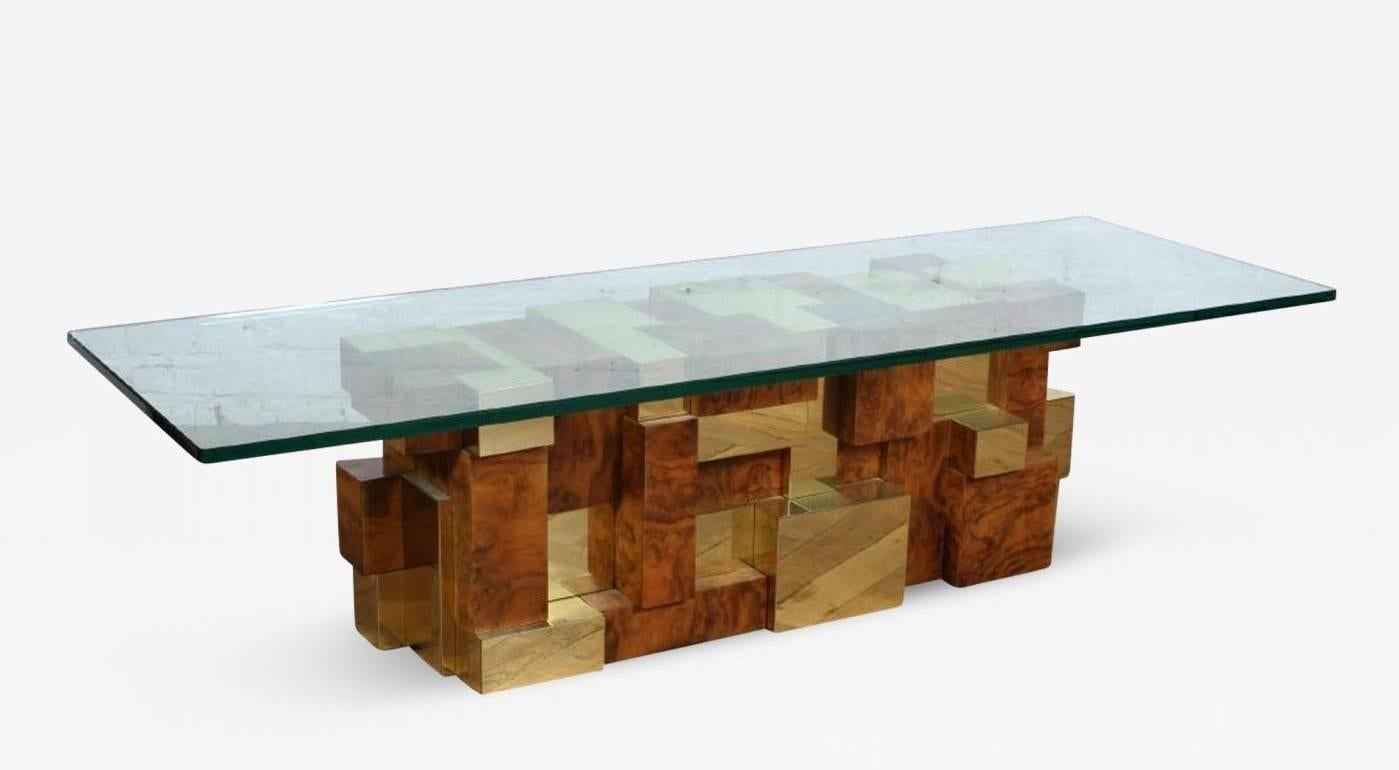 A cityscape multifaceted coffee table by Paul Evans for Directional Inc, circa 1970s. A rarely seen model with square block construction in brass ad burl in a pixel effect.
The base itself is 15.5” x 41.5” x 14.5” and can support a glass top of