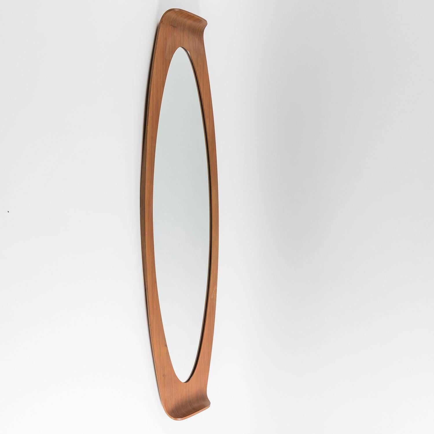 Remarkable wall mirror attributed to Franco Campo and Carlo Graffi for Home. 
Large plywood frame bent on both sides.