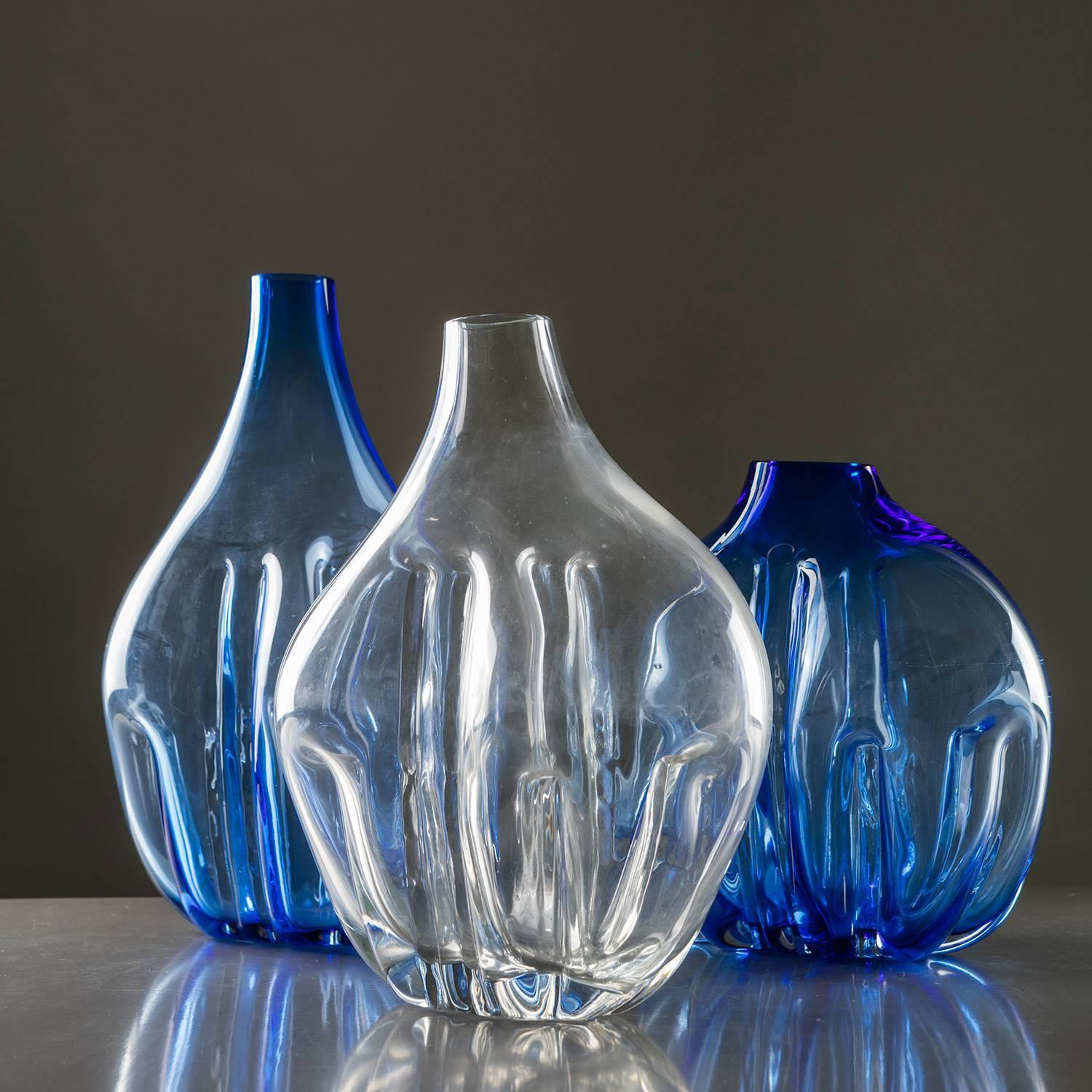 Outstanding Murano glass vases by Toni Zuccheri.
The piece is part of an experimental collection with crystal glass made by Zuccheri blowing the glass against strange shaped molds and worked then with tongs.
Size refers to the tallest piece.