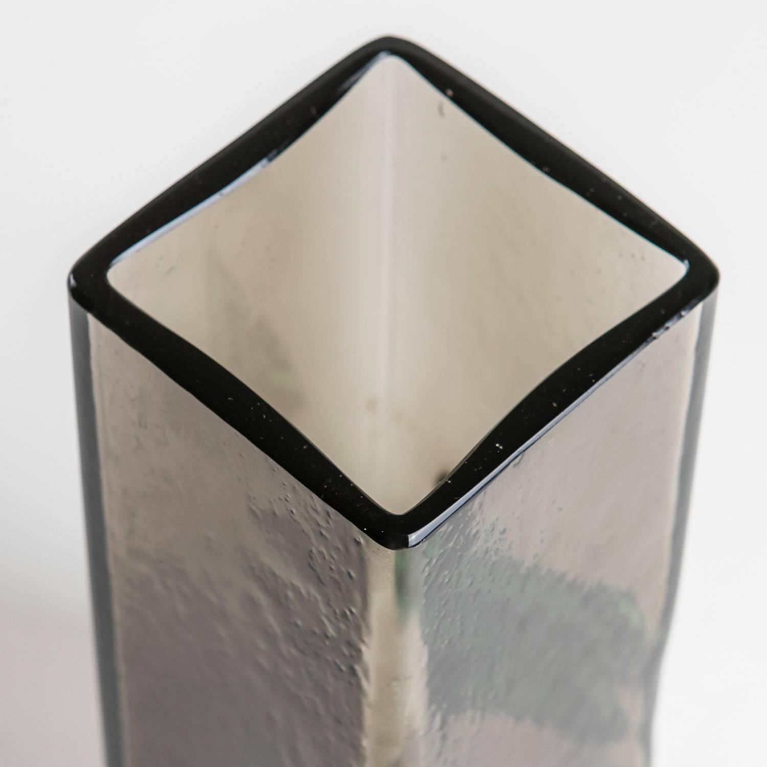 Remarkable vase by Pierre Cardin.
Small quatrefoil green glass decoration on one side and signature behind it.