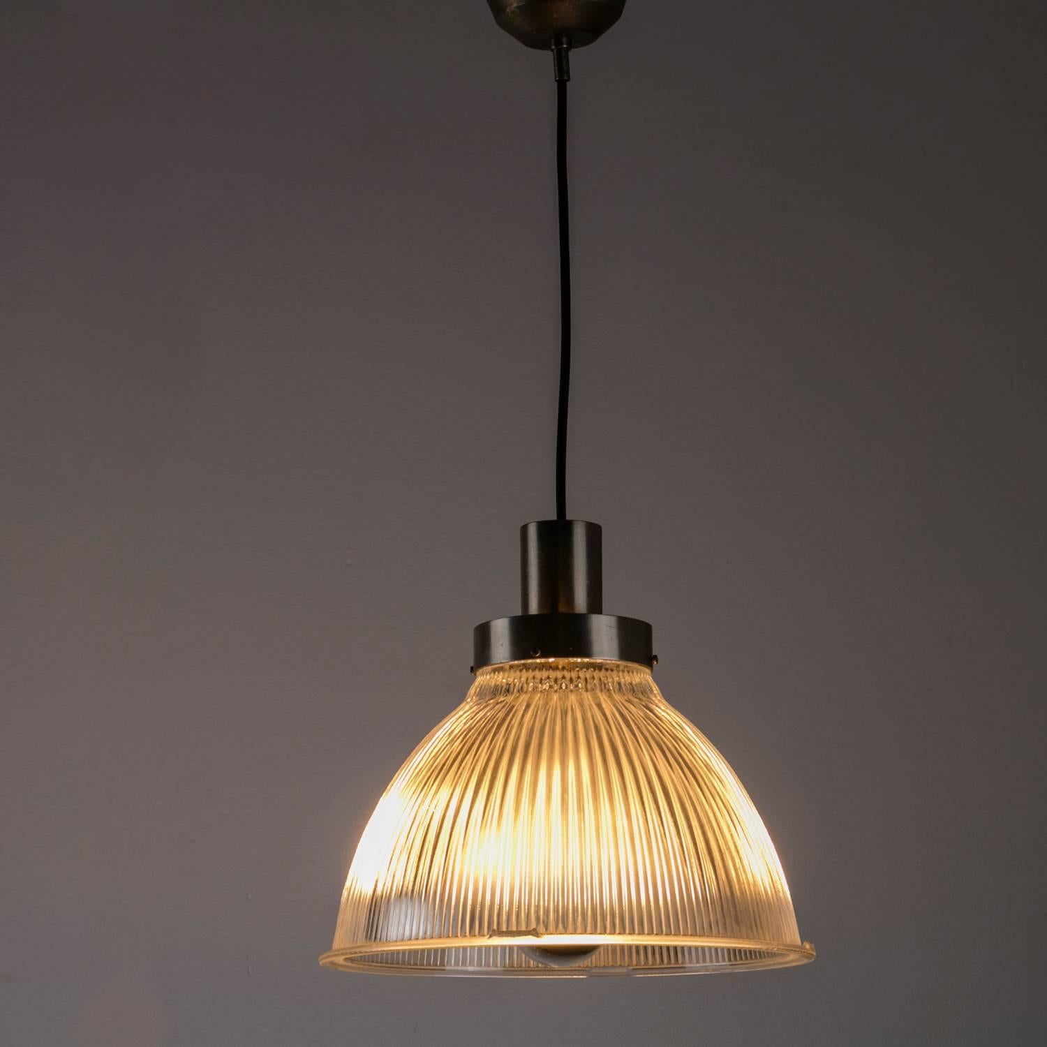Remarkable set of two Italian 1950s pendant lamps.
Nickel-plated frame with industrial pressed glass shade, the pieces have strong connections with BBPR lamps designed for Artemide.