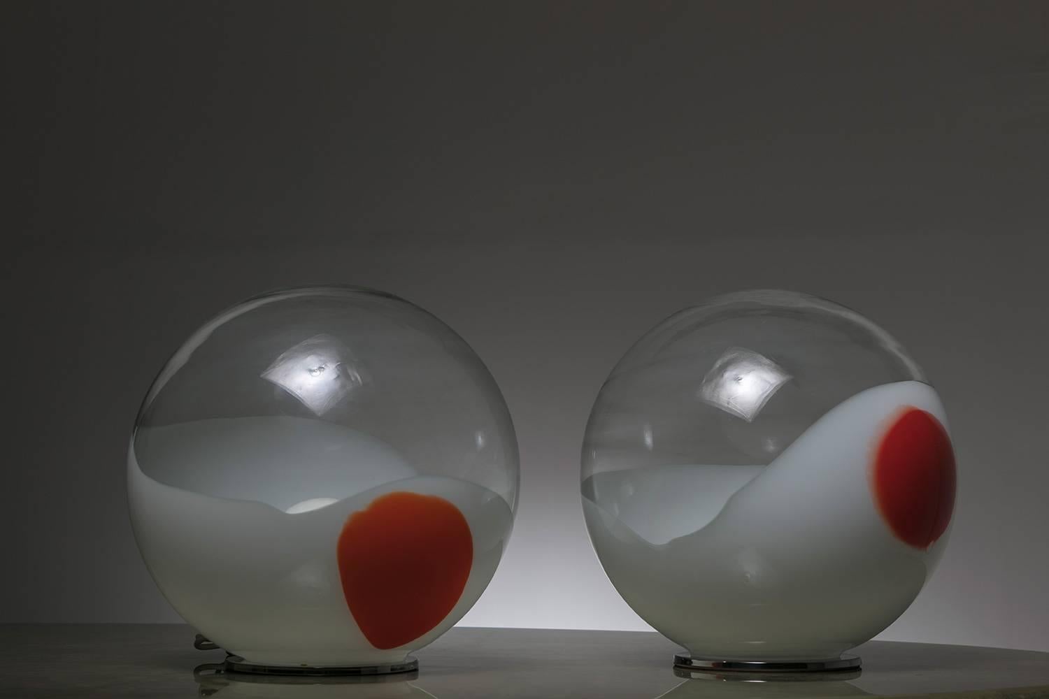 Pair of Murano glass table lamps by Angelo Brotto for Esperia.
The light source is hidden by a first opal glass sphere and then diffused in the big milky and red decorated outer sphere.
        