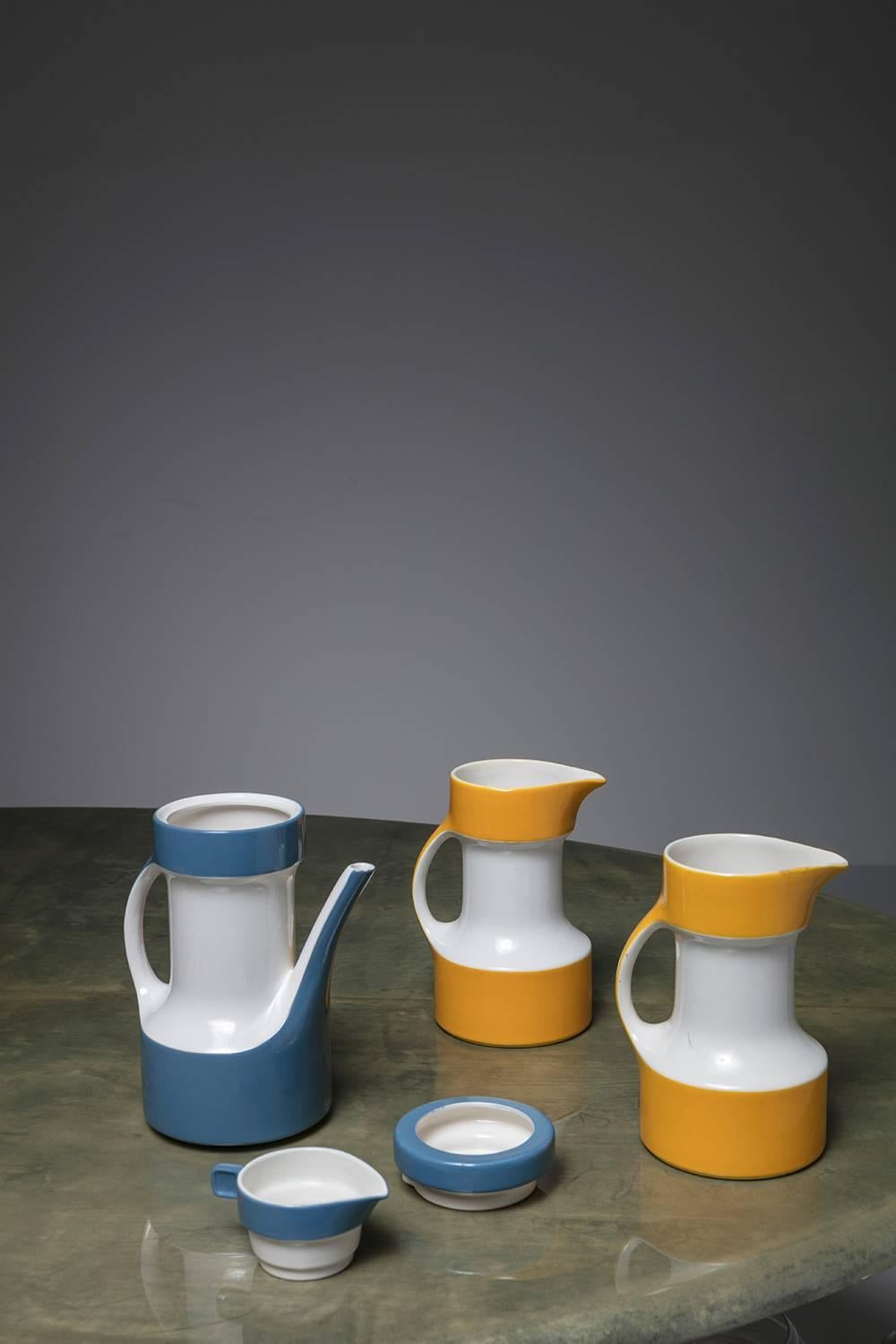 Set of three pitchers by Ceramica Pagnossin, Treviso.
Blue piece features an integrated cup with plate.