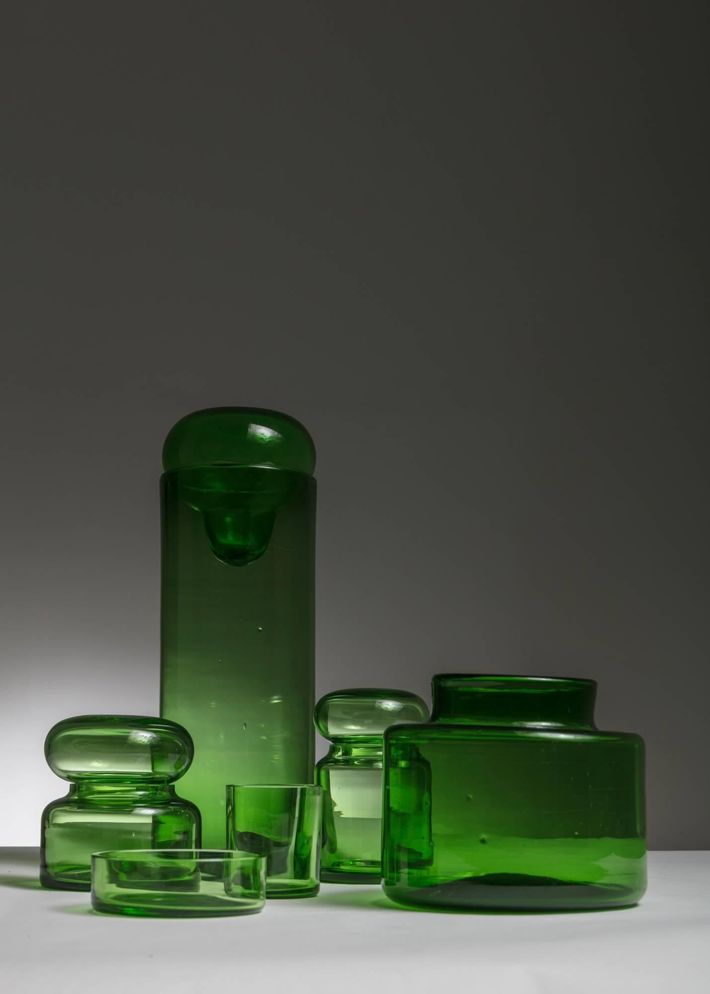 Set of six handblown pieces in Empoli glass.
This thick green glass is composed by two vases, two bottles an ashtray and a glass.