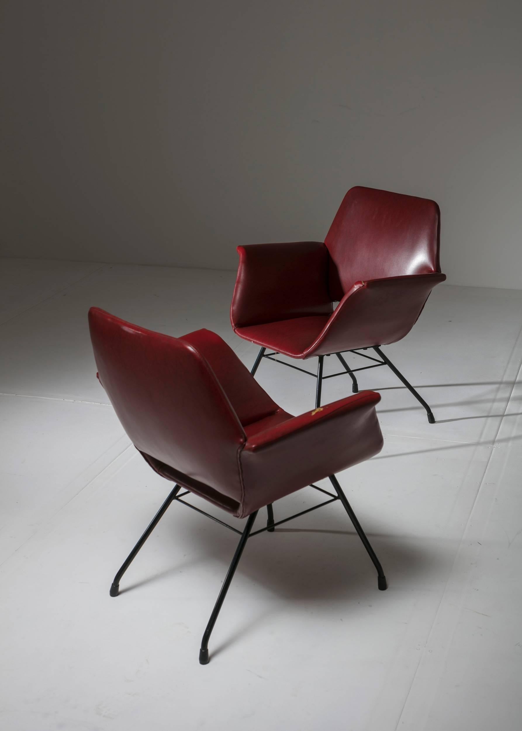 Remarkable set of two Italian 1950s armchairs.
Thin metal frame and sleek shaped seat with visual connections to Joseph-André Motte work.
 