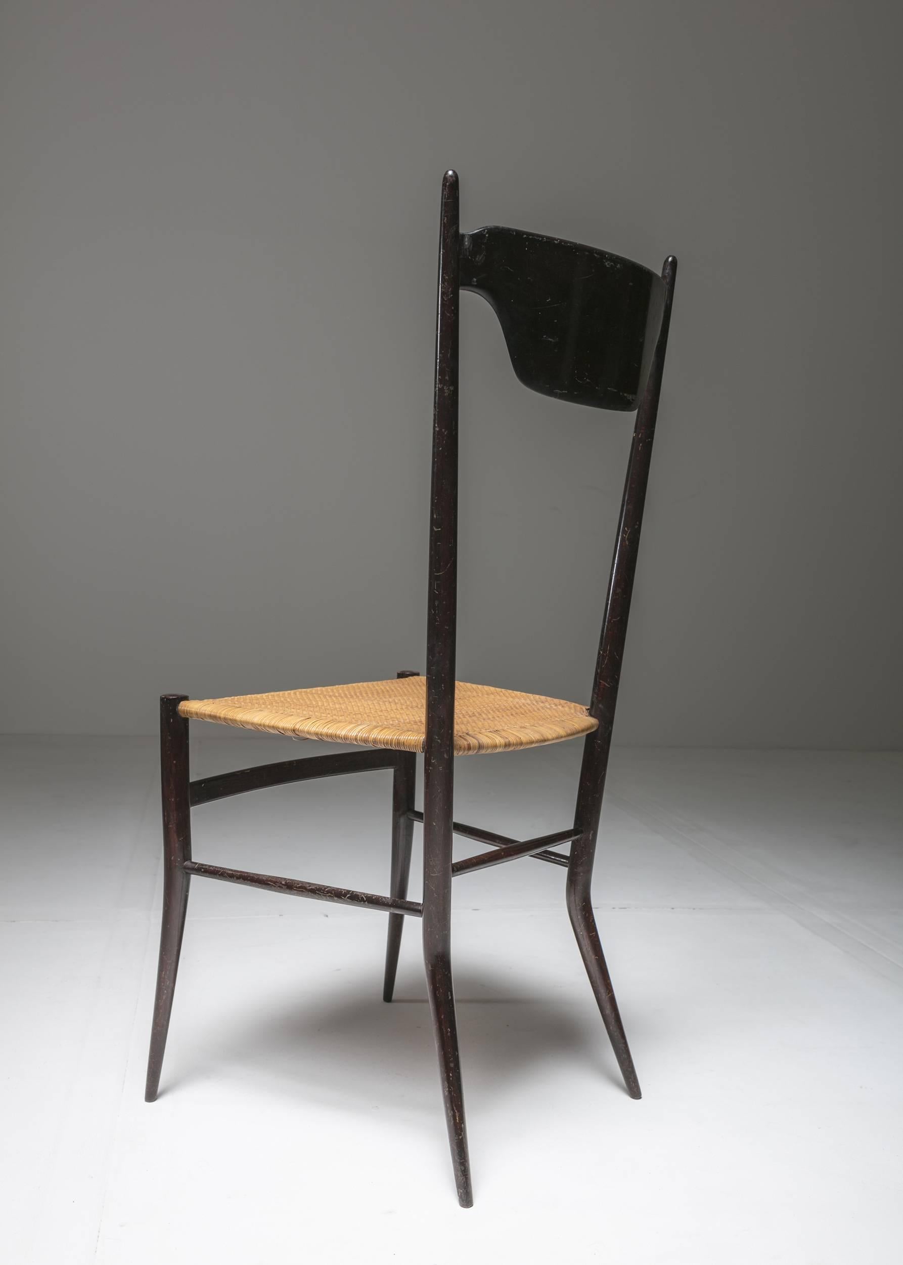 High back Chiavari chair by Sanguineti for Colombo.
Sculptural example of early 1950s, Chiavari production with lean wood frame and wicker covering.
