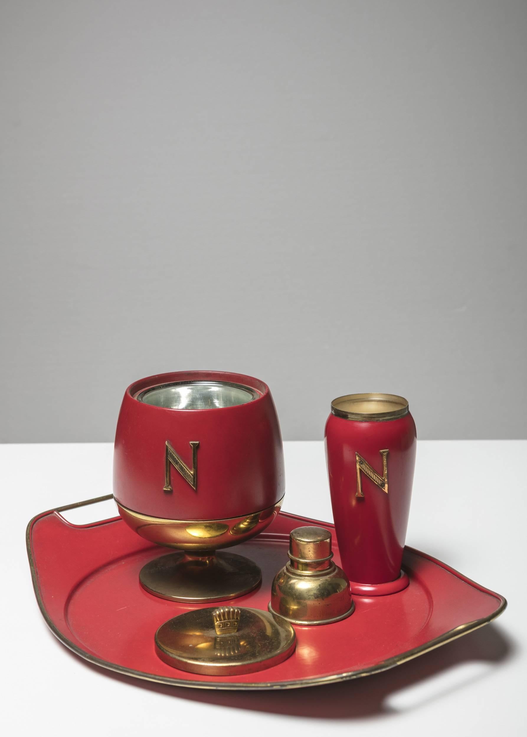 Remarkable bar set by Aldo Tura for Macabo.
N brass letter on ice bucket and shaker on a red background.
Size refers to the tray piece.