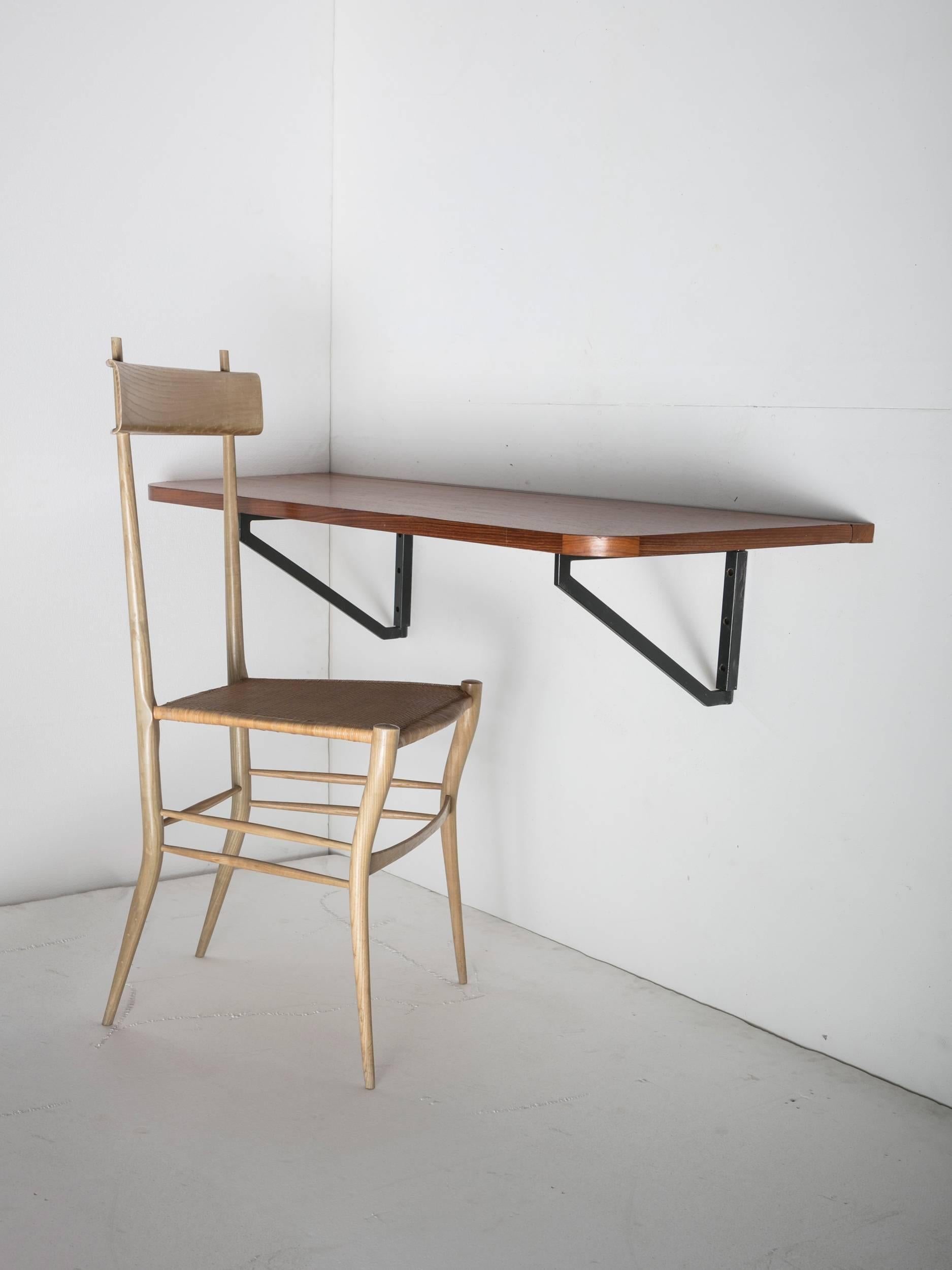 Plywood folding wall desk.
Piece can be used for transit areas or rooms with multiple purposes.
Top is supported by two rotating metal brackets.