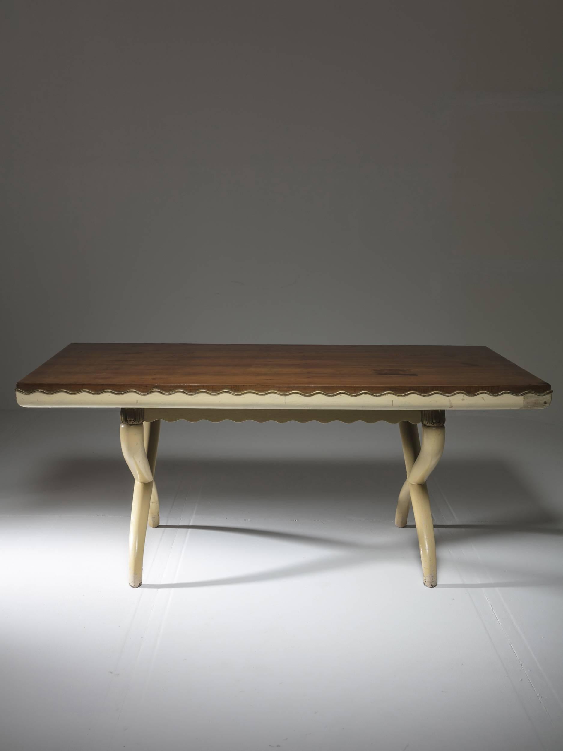 Remarkable desk or dining table in the style of Tomaso Buzzi.
Crossed legs and delicate wood work running all around the wood top.