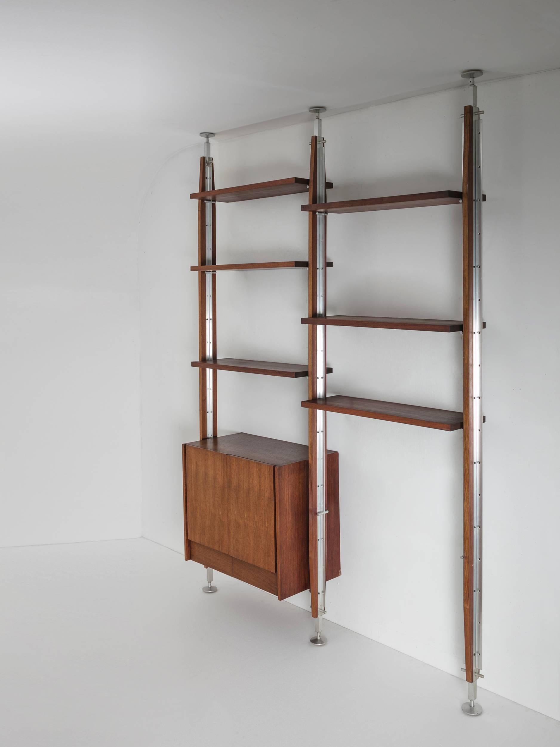 Remarkable bookcase with steel and wood frame.
Three uprights one cabinet and six shelves freely adjustable.
Connection between vertical and horizontal elements is perfectly solved with a cut on the shelf side.
 