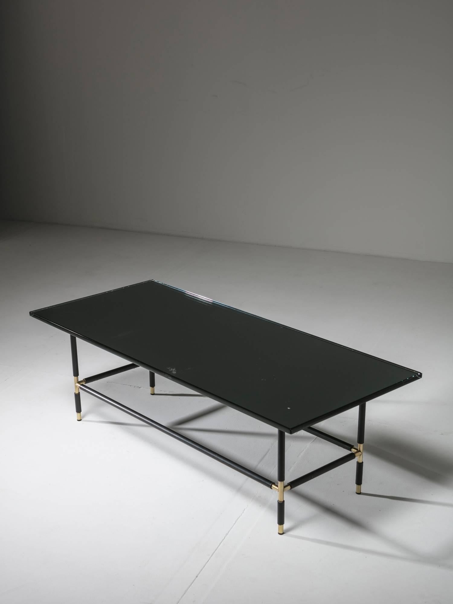 Remarkable coffee table model 1736 by Fontana Arte.
Grey-mirrored thick glass top is supported by a thin metal frame with brass connections.