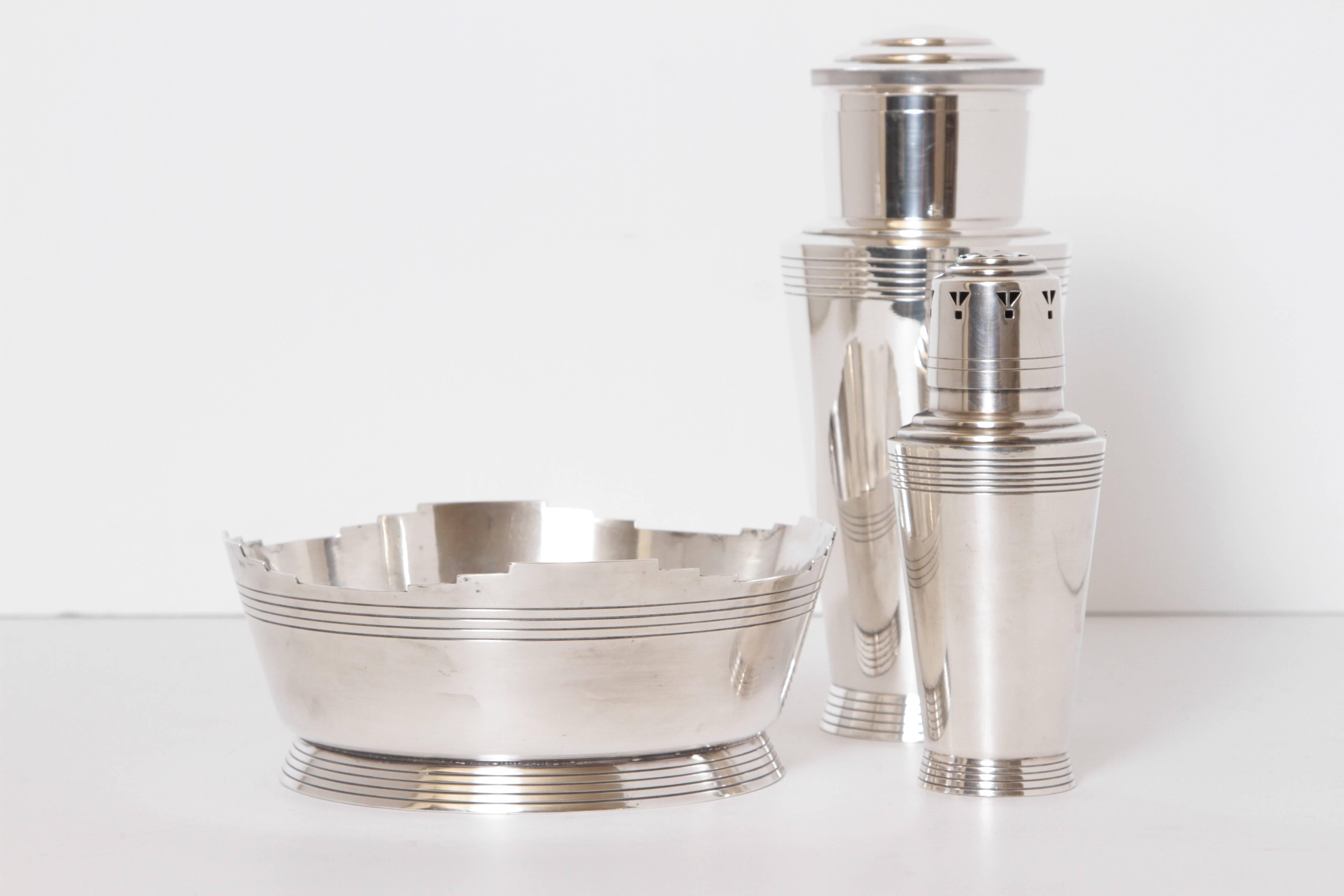 1930s Art Deco Keith Murray Mappin & Webb silver plate bar and table ware trio bar ware

Fine signed examples of Murray's Machine Age Skyscraper designs.
Iconic complete cocktail shaker, impressive matching powdered-sugar Shaker and rare