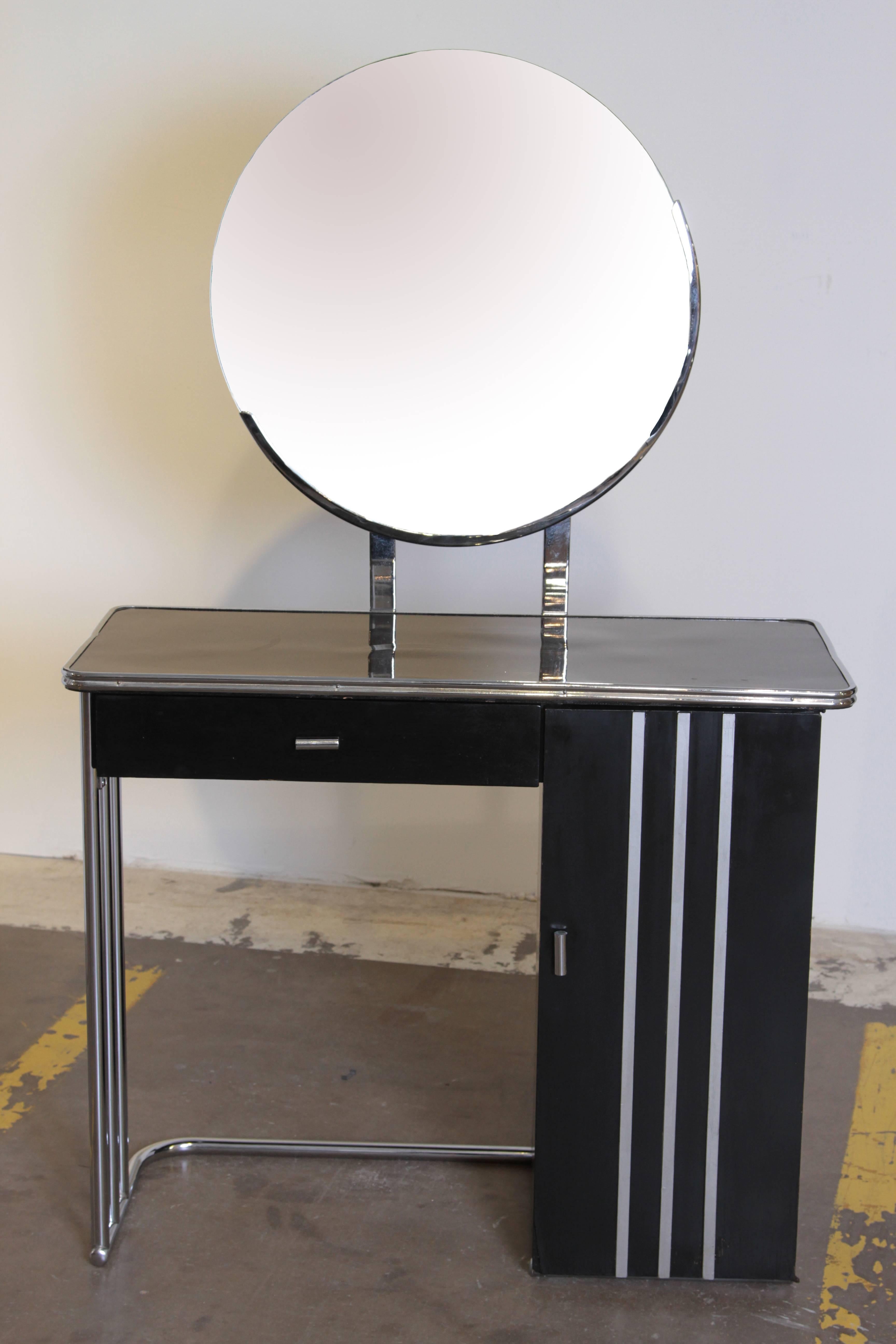 Machine Age Art Deco royal chrome dressing table # 347 by Royal Metal.  Royal Chrome.  Moderne.  Modernist.
Nice streamline speed lines.
Some attribute this design to Donald Deskey, unconfirmed, but from Royal's Michigan City, Indiana