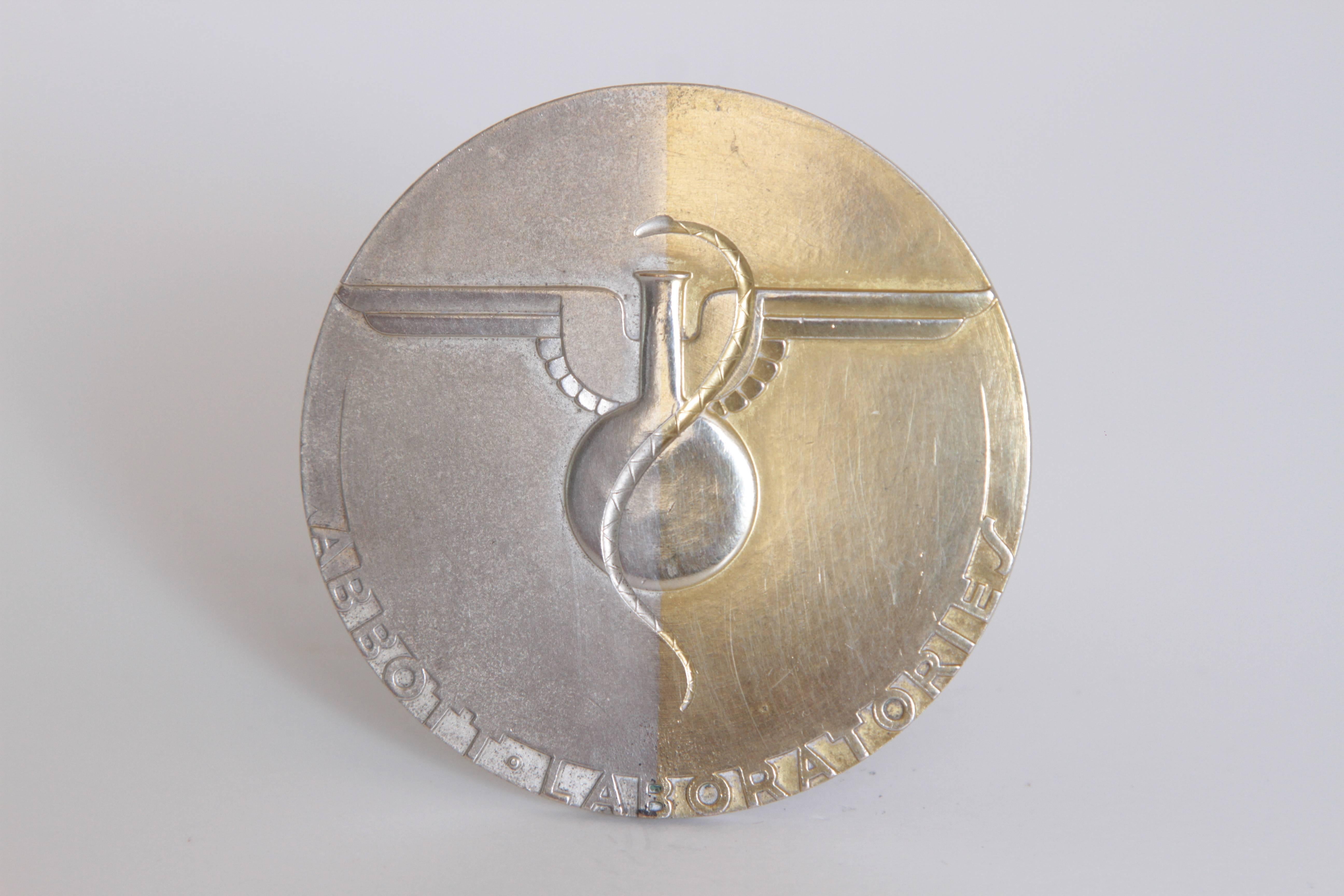 Machine Age Art Deco Raymond Loewy Medallion, Abbott Labs 50th Anniversary

A difficult to source medallion, designed by Loewy and executed by Rene Chambellan for Medallic Arts, with two-tone plated finish.  Loewy's sole medallic design.

The