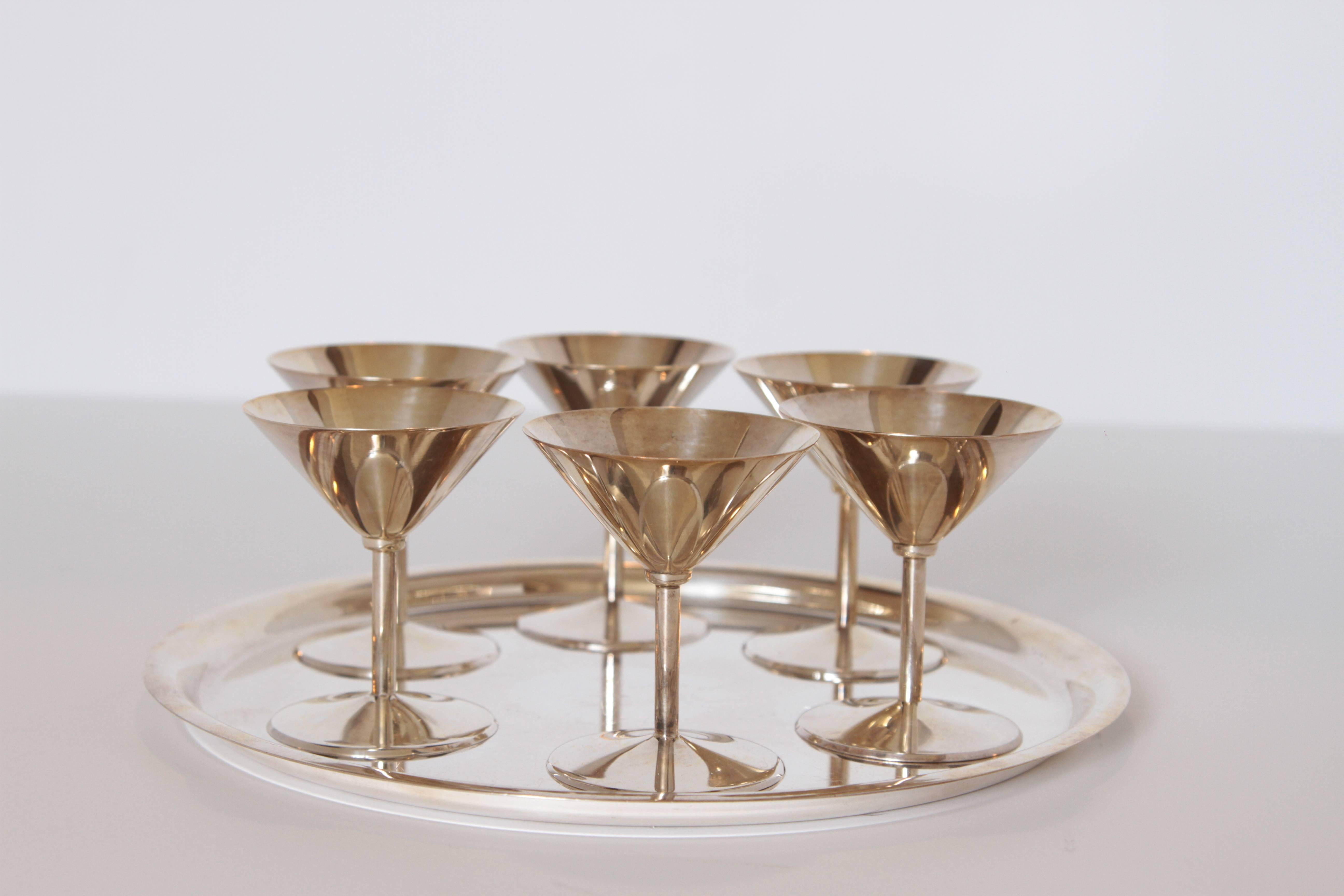 Machine Age Art Deco Silver Plate Cocktail Set by WMF Germany

Very elegant compact Bauhaus influenced set.
Excellent construction quality, with nicely weighted cups.
Six cups and tray. 
Measures: Cups are 3" tall with 2 3/4" diameter