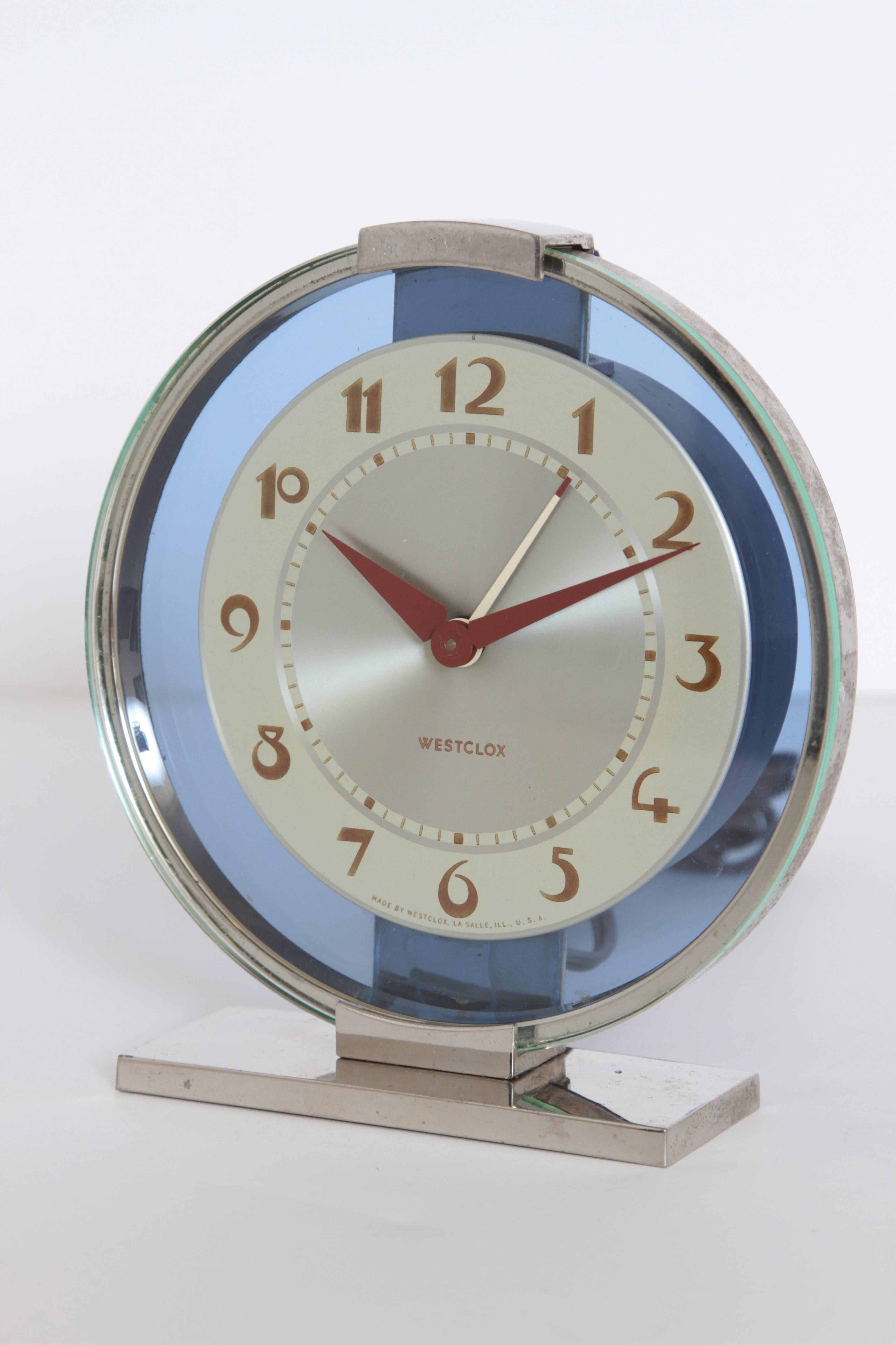 Machine Age Art Deco Westclox desk clock chrome with cobalt glass

Original model.
Polished chrome housing and base.
Original green hued glass on face with non mirrored cobalt glass behind.
Original iconic hands and face, including second hand