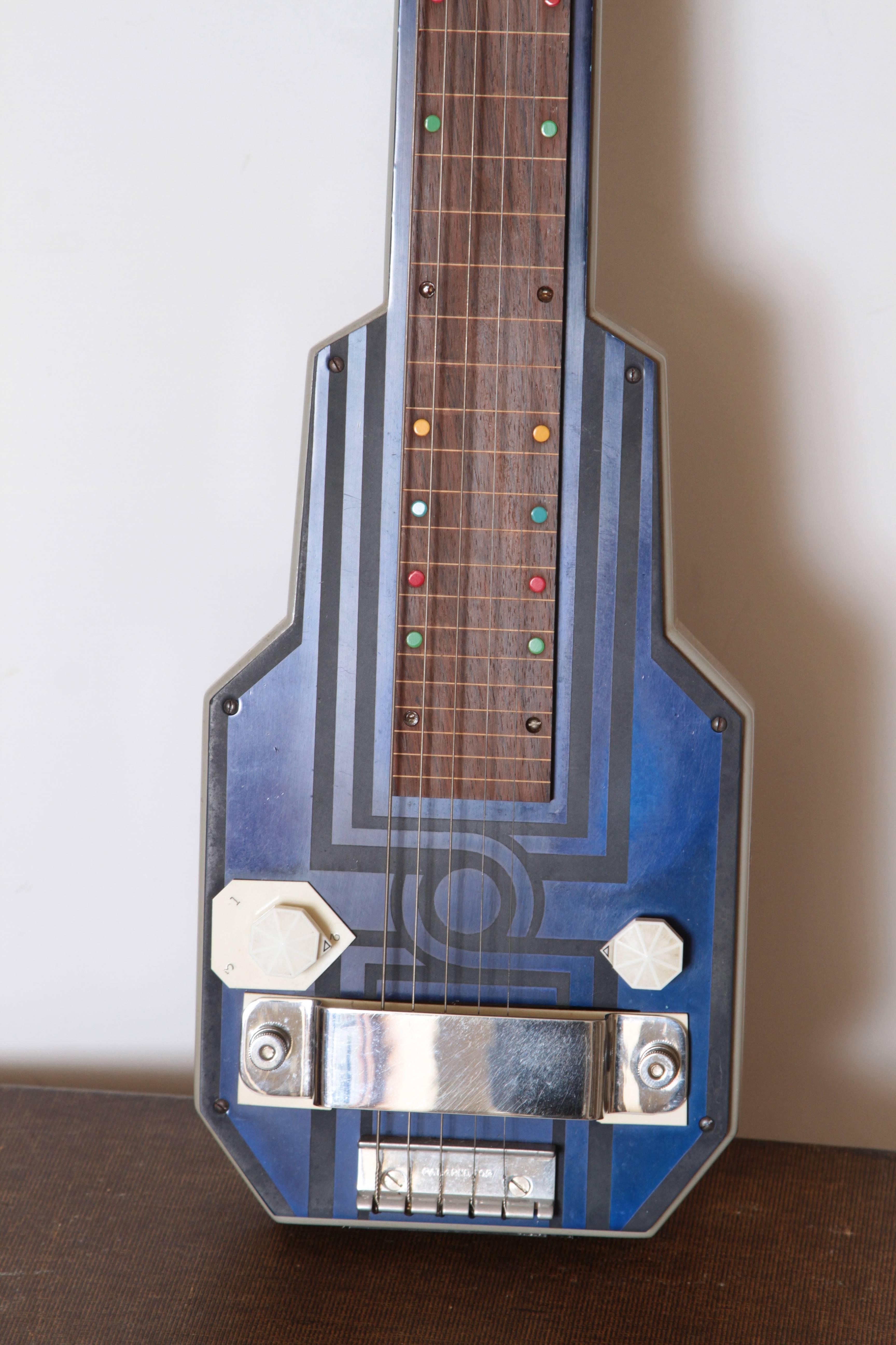 Art Deco Machine Age Epiphone Electar lap steel guitar, patented design, 1937

Original Epi Stathopoulos patented design, in etched cobalt catalin (bakelite) laminate.

Model M, Hawaiian, stamped 2488 into the headstock, which appears to date it