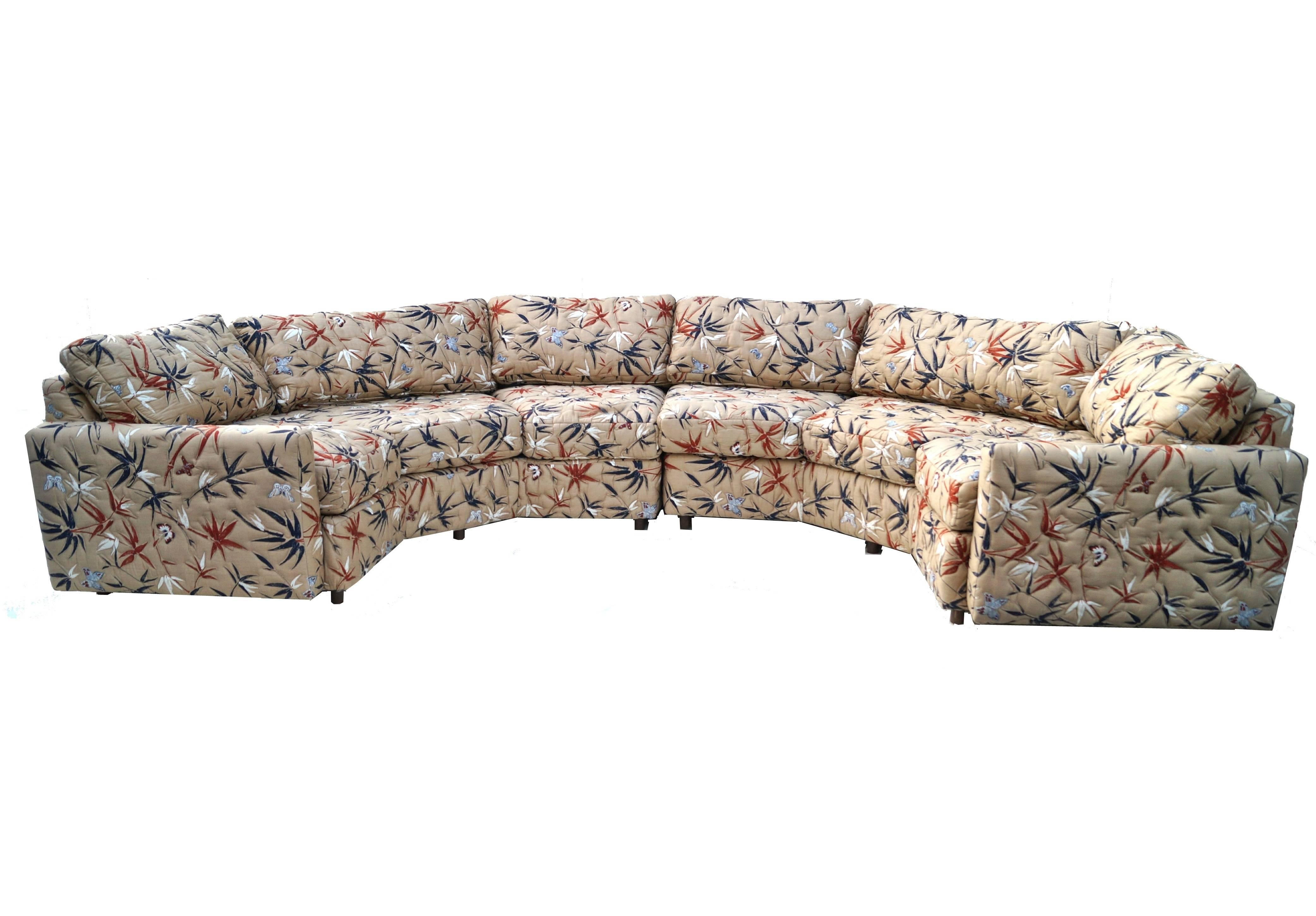 This beautiful mid-century modern two-piece sofa has three sides each when separated. When together it has 5 sides, not including the sides where the armrests go. It is a tan color with Black and rust bamboo and butterflies. Would go great with