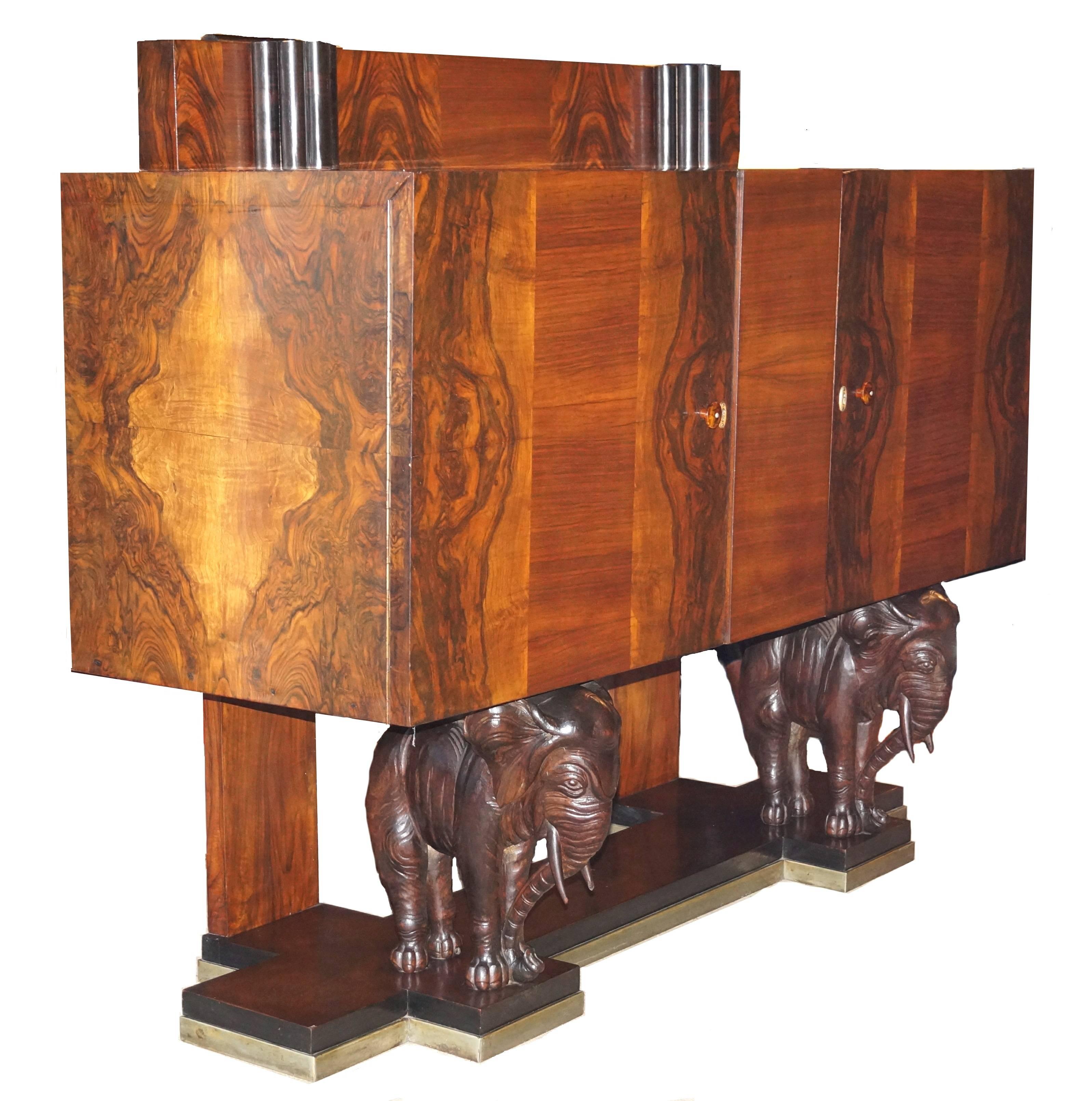 Carved elephant sideboard buffet credenza. Measures: Height of backslash is 47 1/2". Height to top of cabinet is 41 5/8".