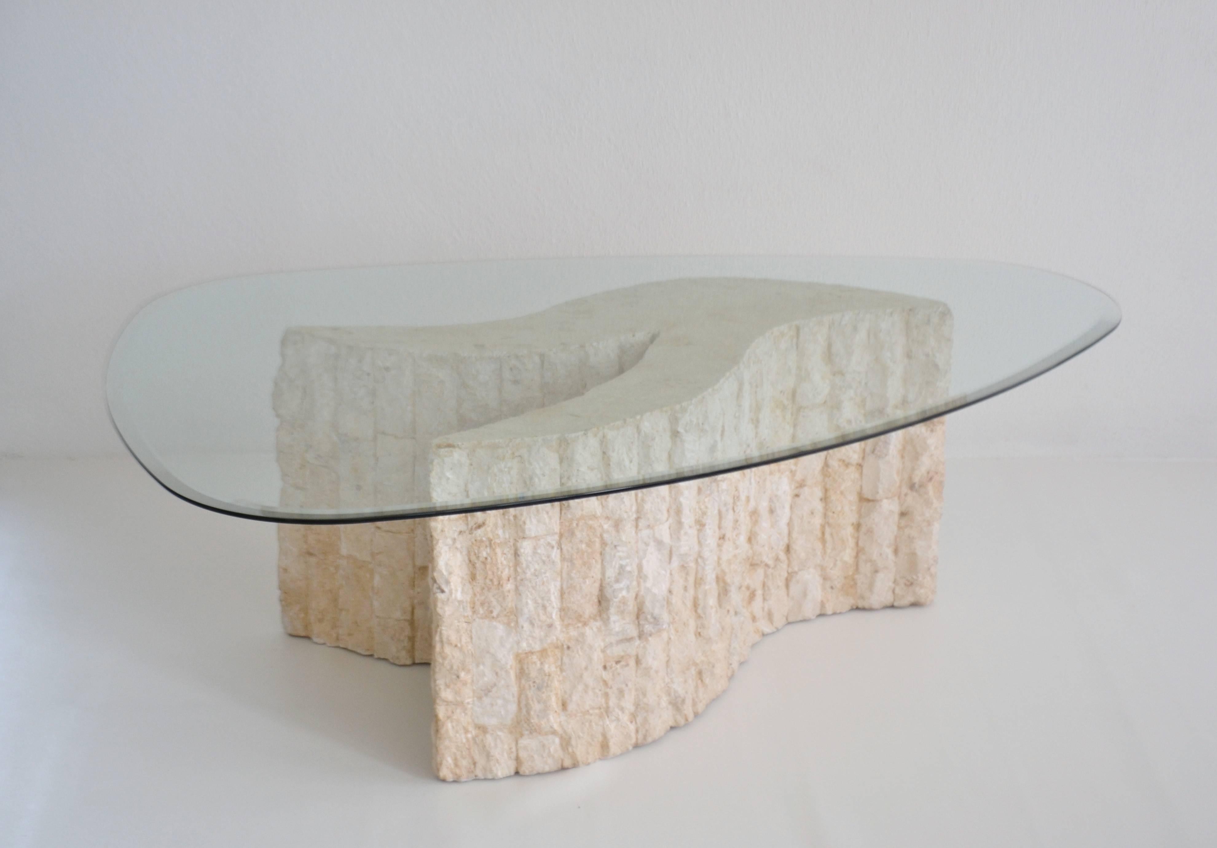 Striking Postmodern abstract form tessellated marble coffee table, circa 1970s-1980s. This stunning sculptural artisan crafted cocktail table is designed of cut rough hewn stone and accented with an organic boomerang glass top. 
Measurements: 
Glass