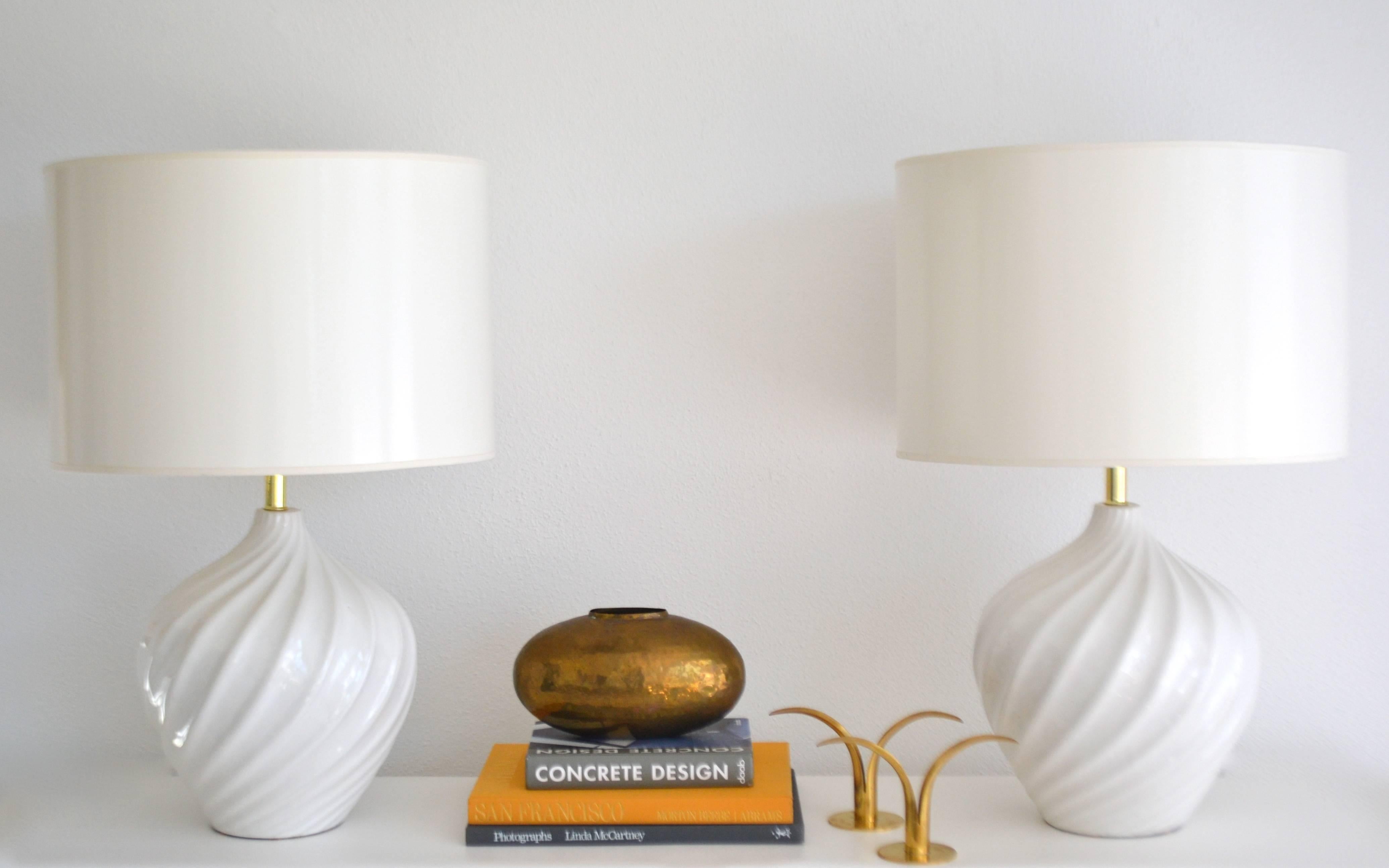 Stunning pair of Mid-century Blanc de Chine Jar form table lamps, circa 1960s. These striking lamps are artisan crafted to resemble rippled crest patterns and are wired with brass fittings.
Shades not included.
Measurements: 
Overall: 28.5