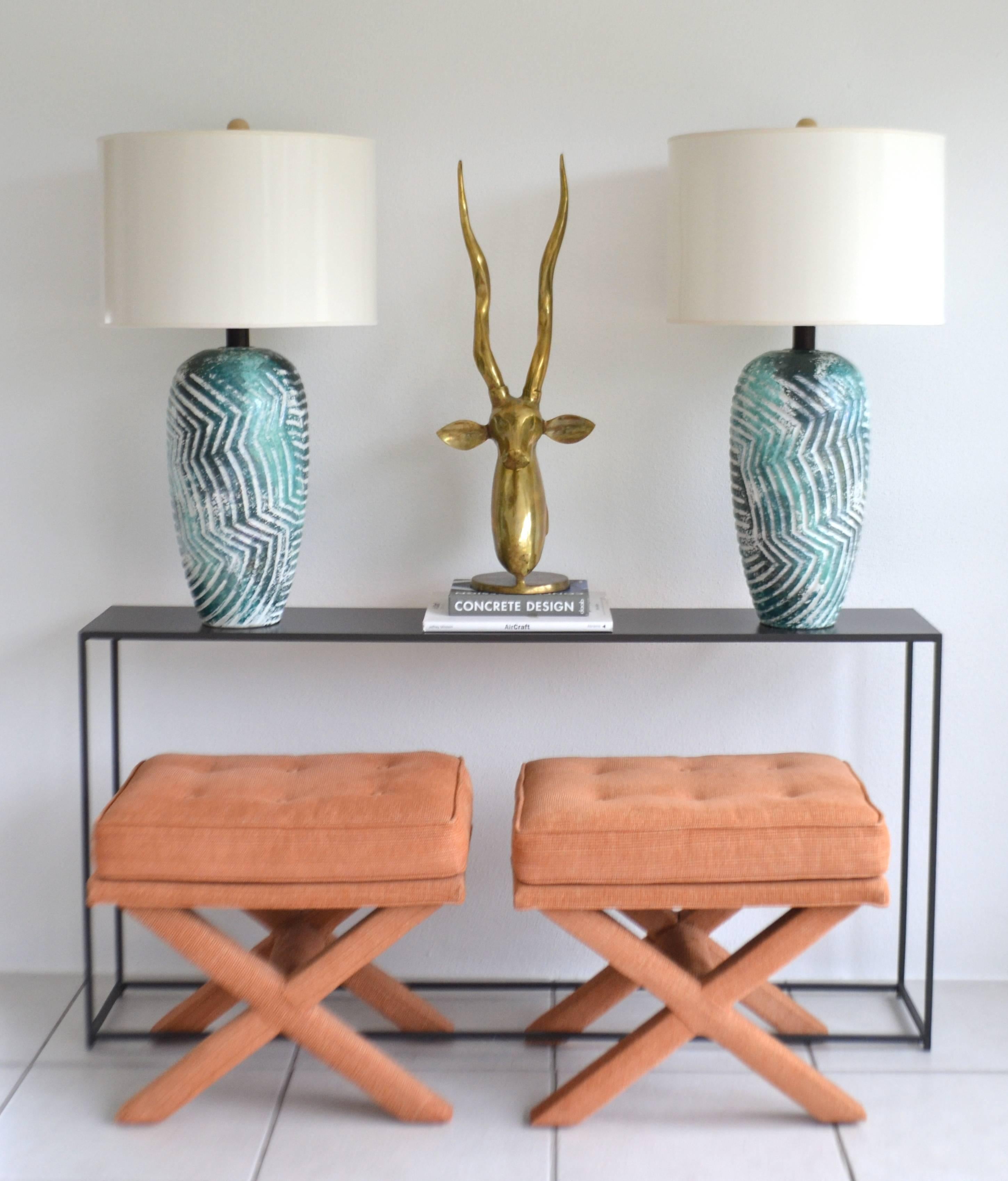 Striking pair of graphic Postmodern ceramic jar form table lamps, circa 1970s-1980s. These highly decorative artisan crafted polychrome drip glazed lamps are designed with an incised geometric pattern and wired with brass fittings.
Shades not