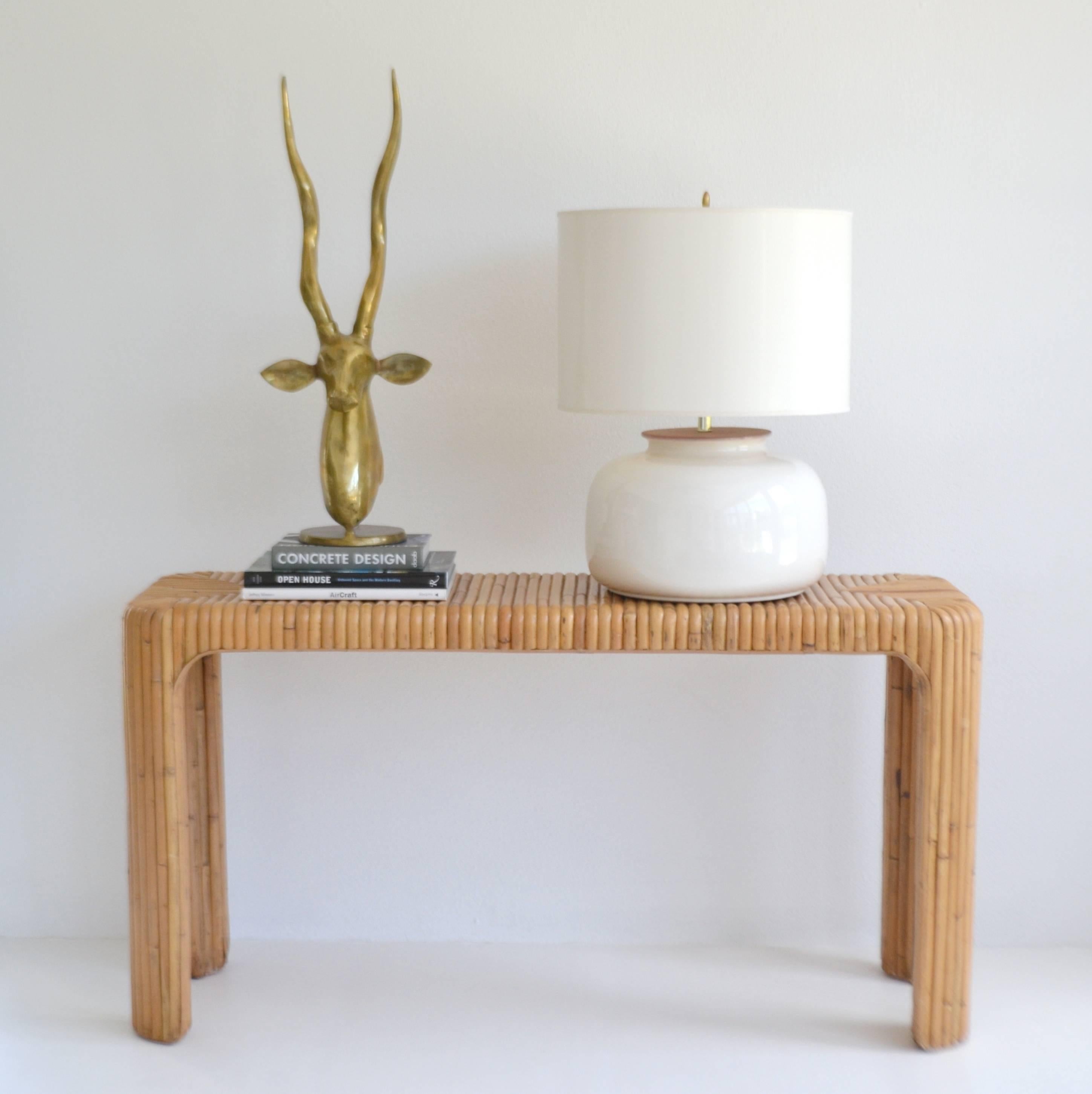 Sleek midcentury bent bamboo console table, circa 1960s-1970s. This striking decorative sofa table is artisan crafted and designed of split bamboo over a hardwood frame.