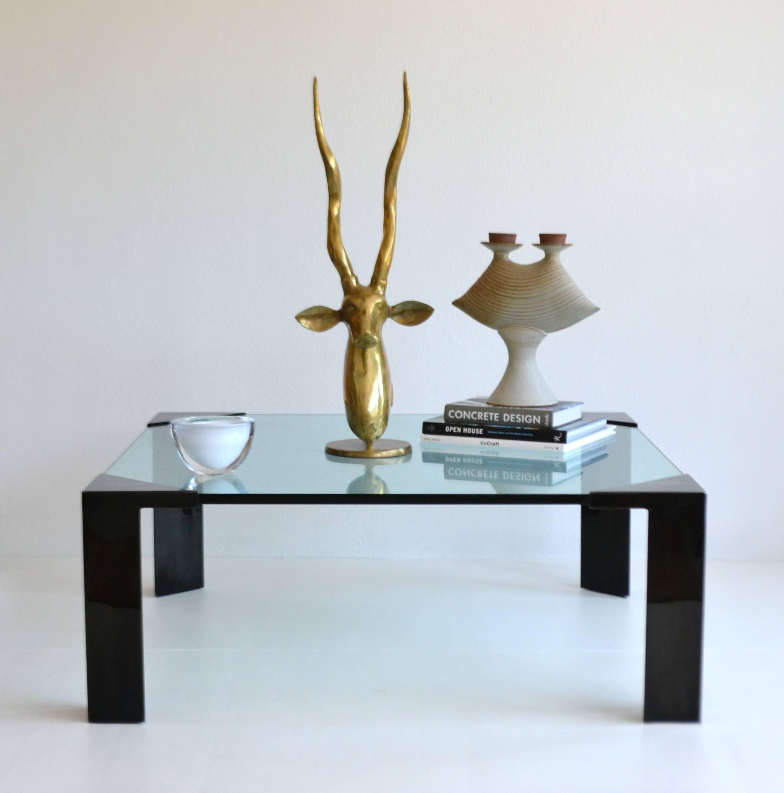Striking Postmodern glass top cocktail table, circa 1980s. This sculptural square coffee table is designed of 3/4