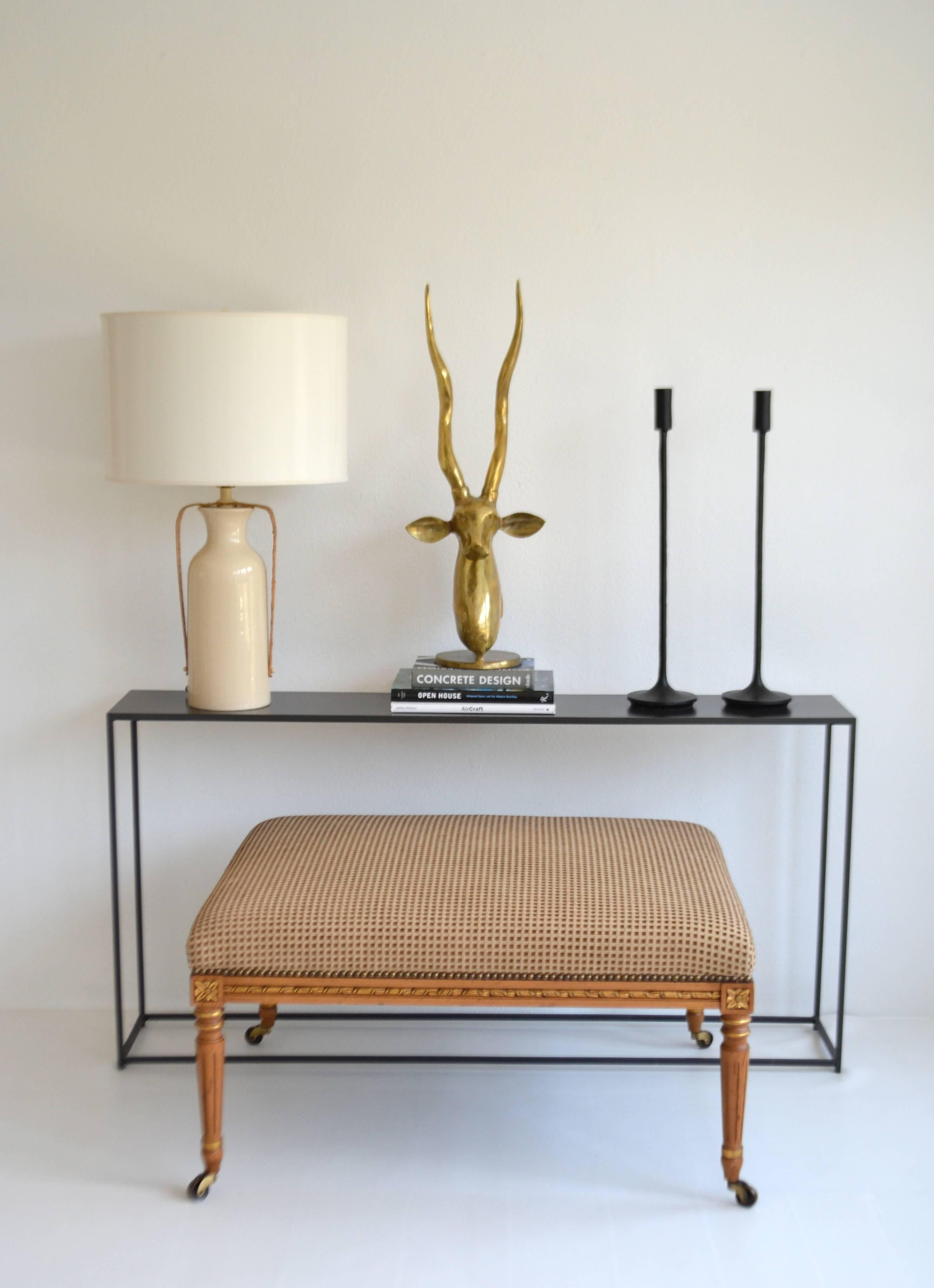 Striking Mid-Century cream glazed jar form table lamp, circa 1960s-1970s. This sculptural lamp is accented with rattan and wired with brass fittings.
Shade not included.
Measurements:
Overall: 29